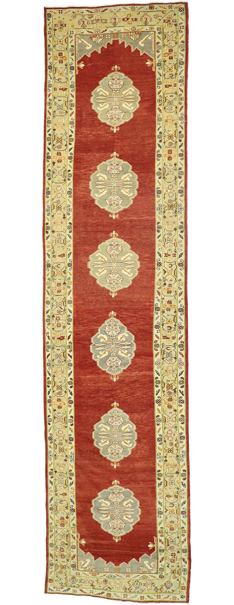 50601 Vintage Turkish Oushak Runner with Jacobean Style, Extra-Long Hallway Runner. This hand-knotted wool vintage Turkish Oushak runner features cusped medallions with ram's horn at either end  floating in an abrashed red backdrop. Each medallion
