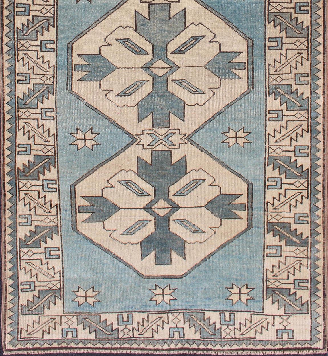 Vintage Turkish Oushak runner with medallions in blue colors and beige
Medallion Design Turkish vintage rug with tribal designs, rug EN-176550, country of origin / type: Turkey / Oushak, circa 1940

This vintage Turkish Oushak carpet (circa