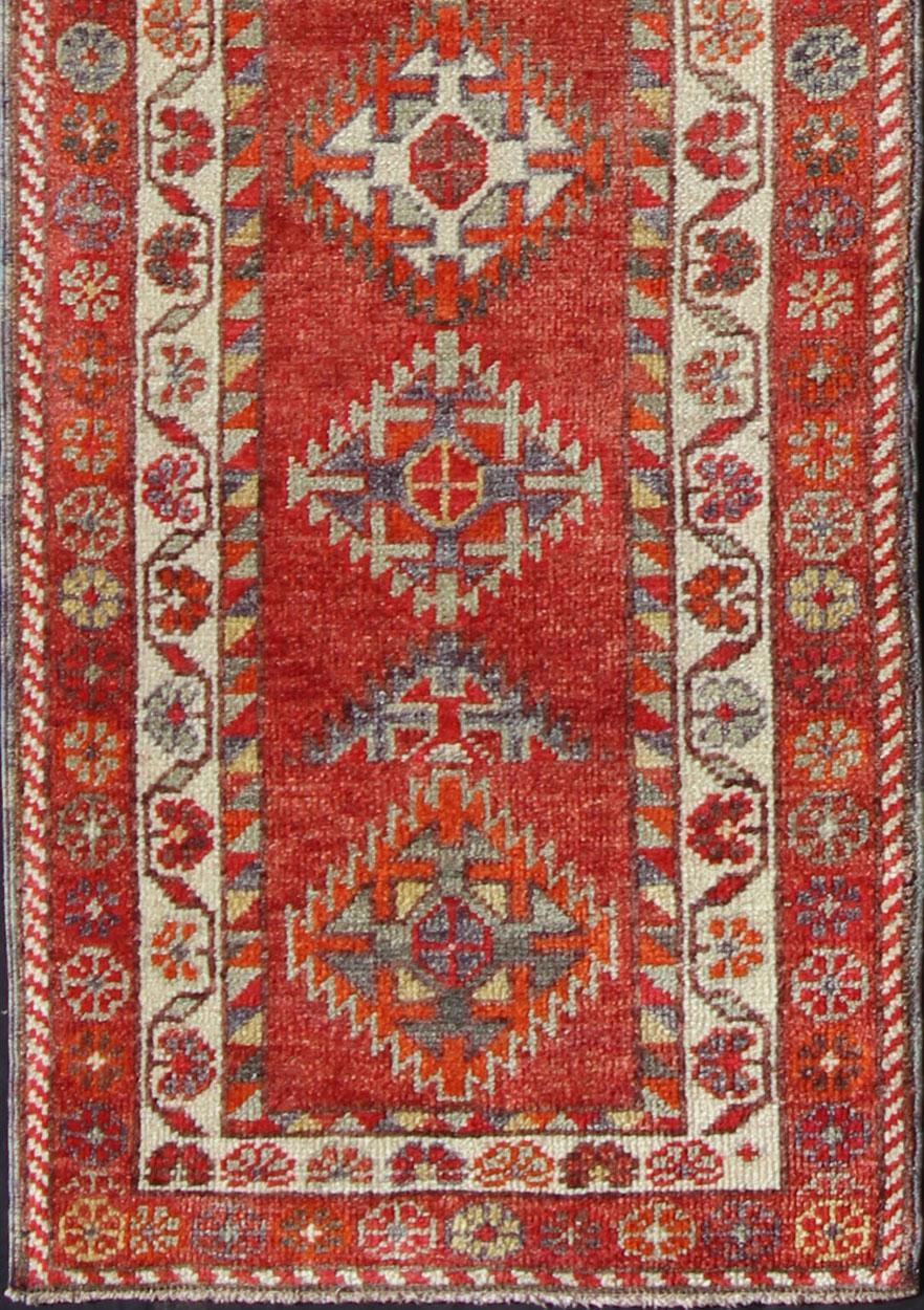 Measures: 2'7'' x 11'6''.
This Oushak runner from mid-20th century Turkey features an all-over multi-medallion design rendered in geometric patterns and a wide variety of color tones, including reds, oranges and browns.

Diamond Medallion Oushak,