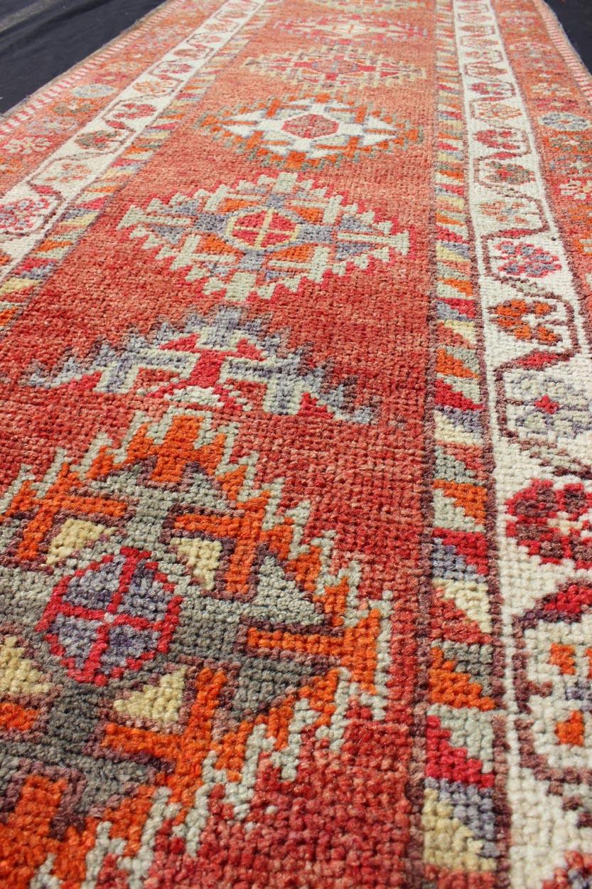 Mid-20th Century Vintage Turkish Oushak Runner with Medallions in Rust Red and Multi Colors For Sale