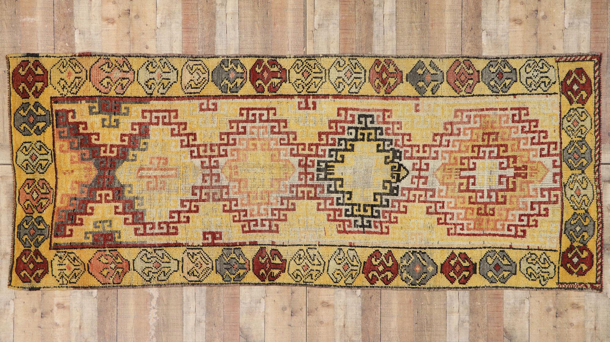 53258 vintage Turkish Oushak runner with Mid-Century Modern style. Dazzling like a tilt a whirl of flower petals, this hand knotted wool vintage Turkish Oushak runner features a playful, colorful display. A row of linear, multi-color hooked diamonds