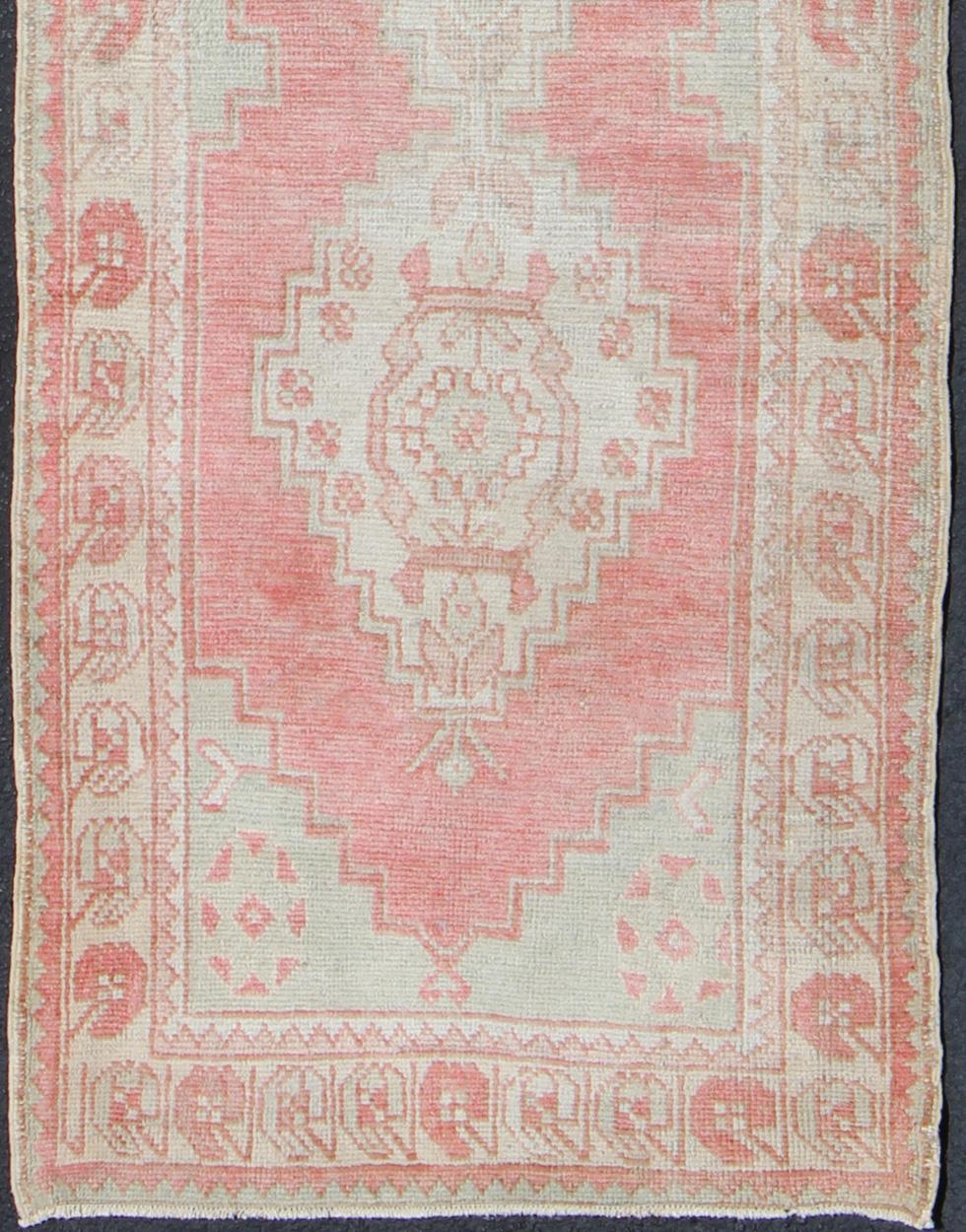 Vintage Oushak runner from Turkey with vertical medallion design in coral, ivory, and light green, rug en-176247, country of origin / type: Turkey / Oushak, circa 1940

This beautiful vintage Oushak runner from 1940s Turkey features a Classic