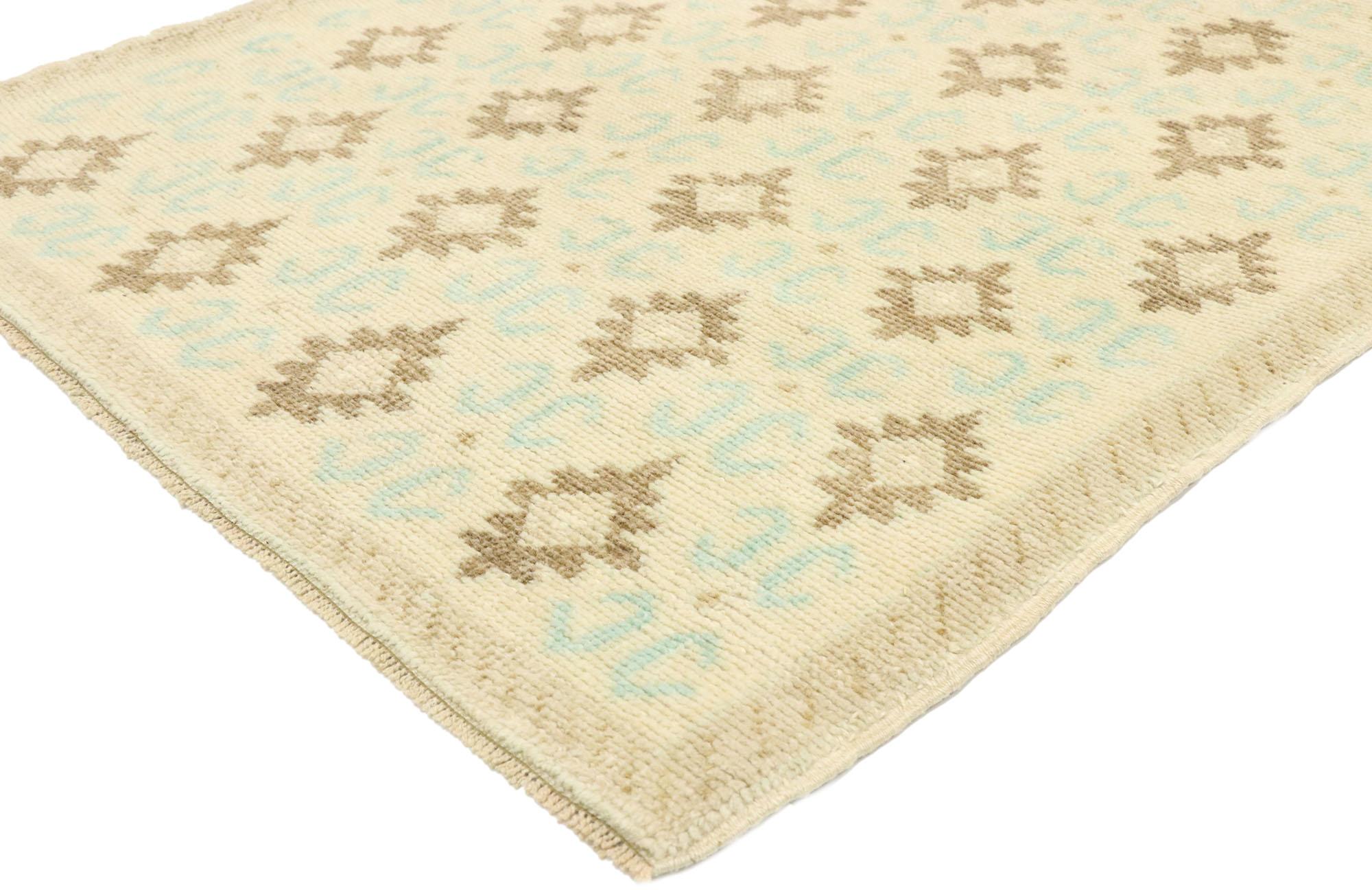 52986, vintage Turkish Oushak runner with Rustic French Provincial Chateau style. Striking the perfect balance of understated elegance and symmetry with soft, bespoke vibes, this hand knotted wool vintage Turkish Oushak runner beautifully embodies a