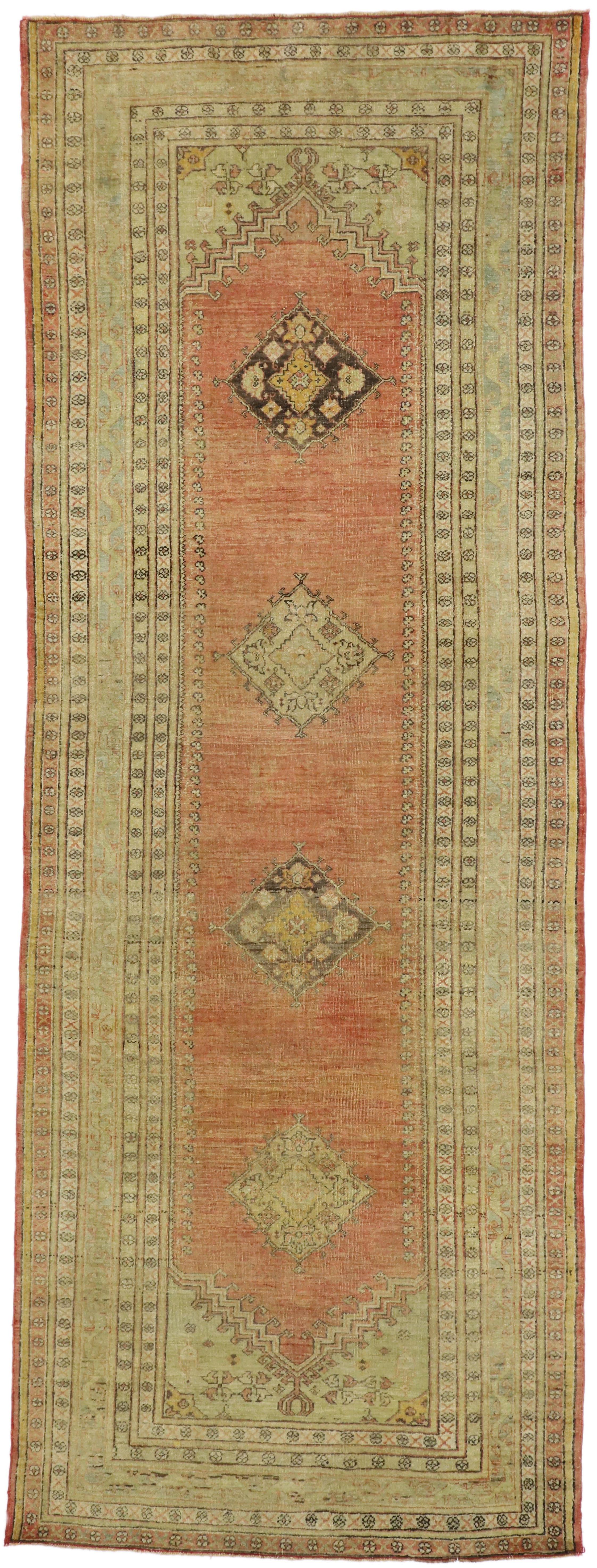 52250, vintage Turkish Oushak runner with soft muted colors. Rustic and refined, this hand knotted wool vintage Turkish Oushak runner beautifully embodies Mission style and rustic vibes. The open and abrashed field highlights four diamond-shaped