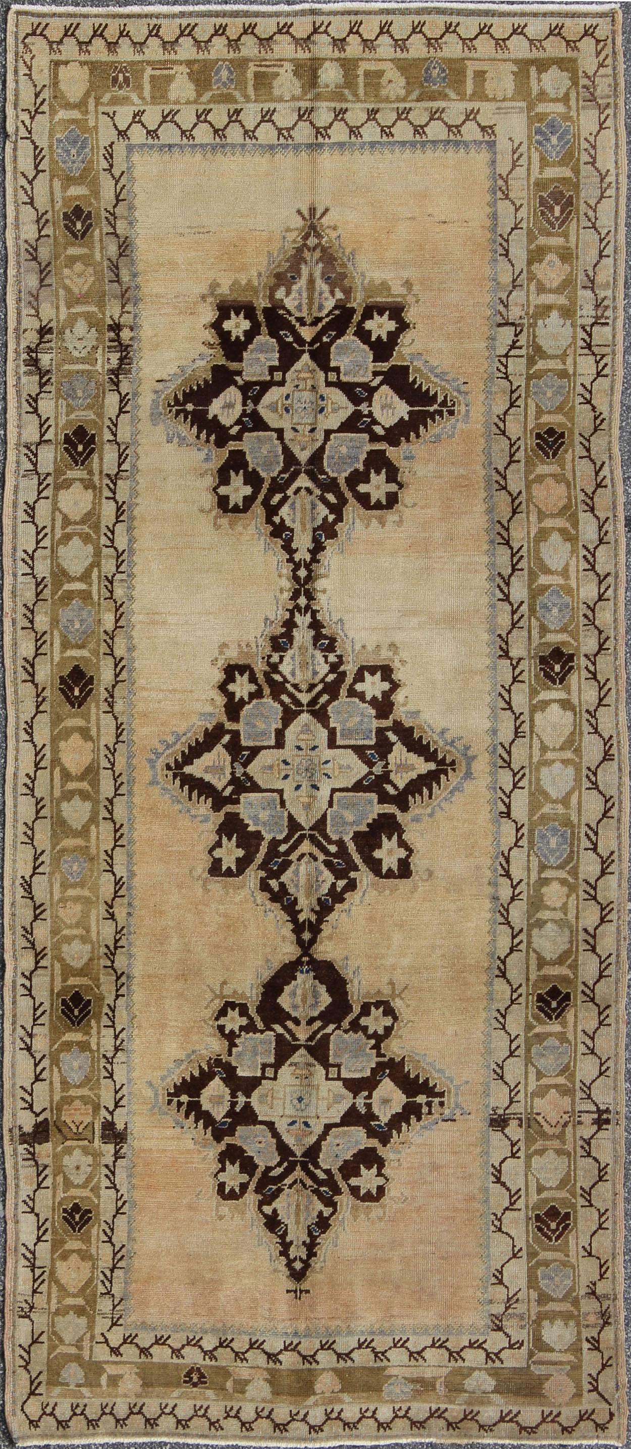 Vintage Turkish Oushak runner with starburst medallion in green, brown and beige. Rug/EN-92278, Vintage Runner, Vintage Turkish Runner
This beautiful antique Turkish rug was woven during the early part of the 20th century and displays a stunning