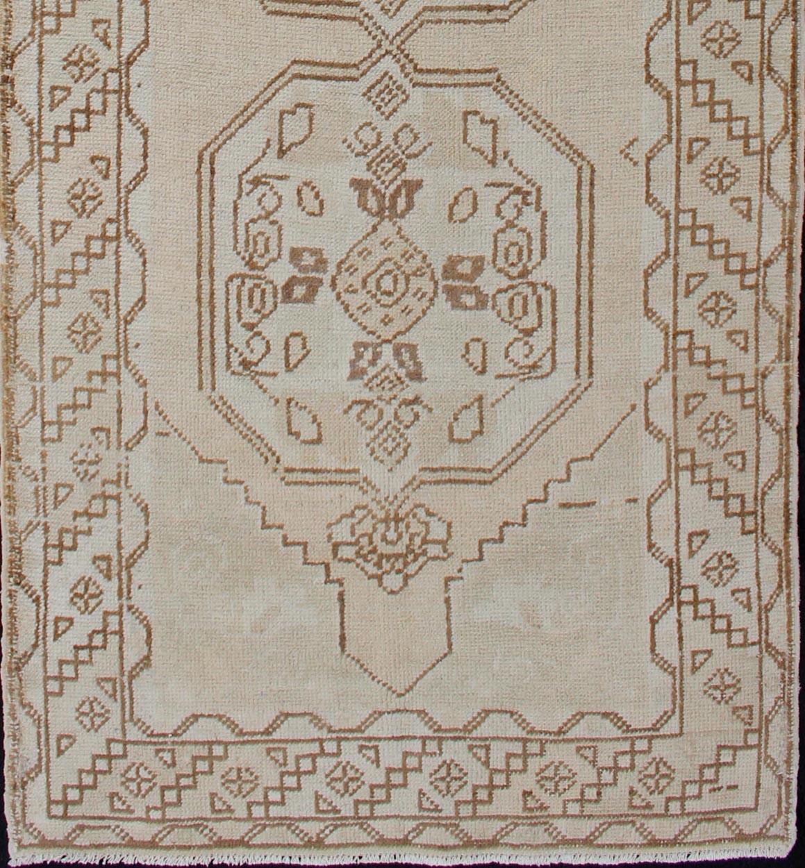 Turkish Oushak vintage carpet, rug en-176166, country of origin / type: Turkey / Oushak, circa 1950

This Oushak rug from Turkey features a tri-medallion design flanked by various stylized motifs and rendered in natural tones.
Measures: 3'3 x 9'8.