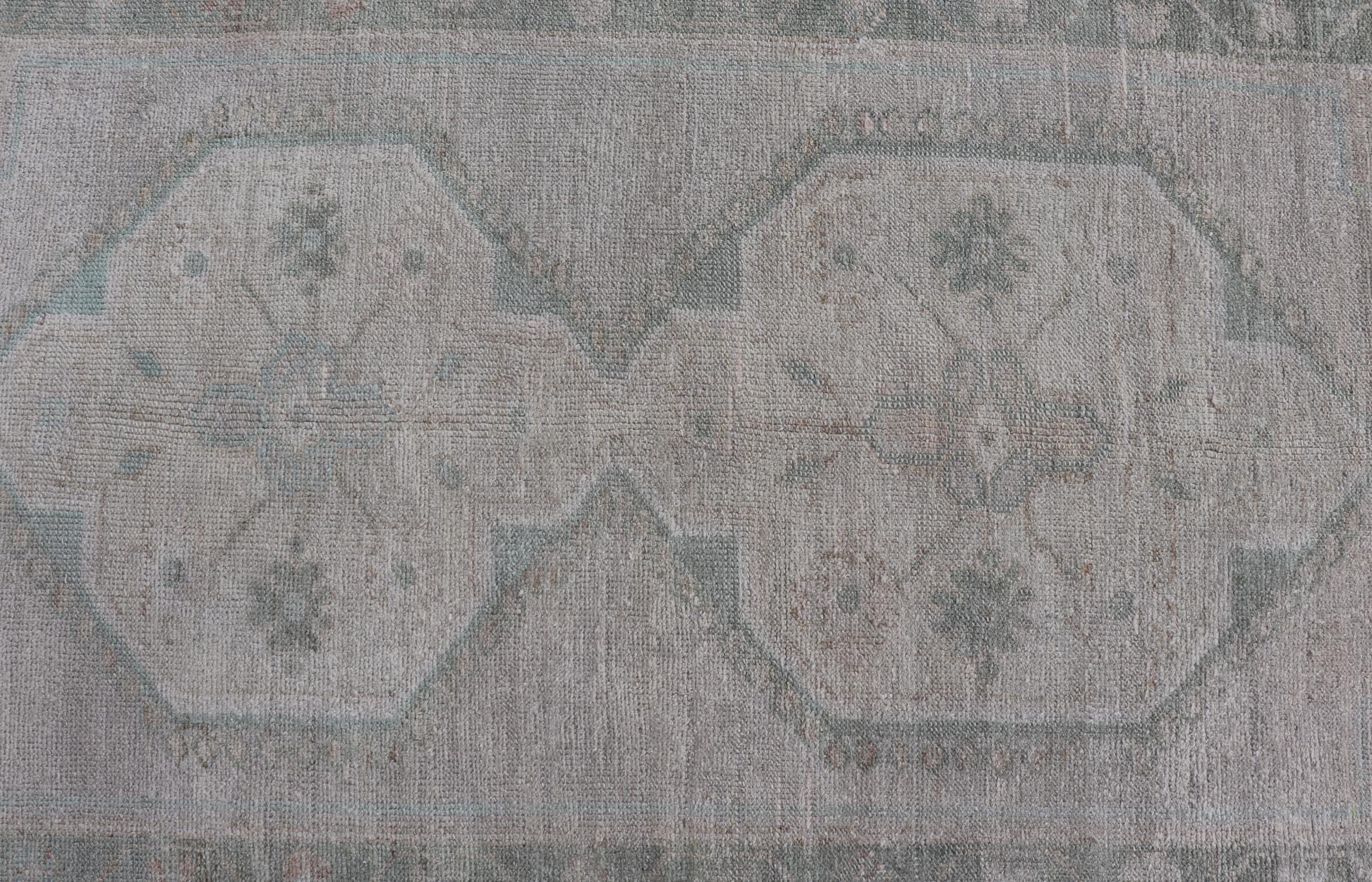 Hand-Knotted Vintage Turkish Oushak Runner with Subdued Geometric Medallions in Light Tones For Sale