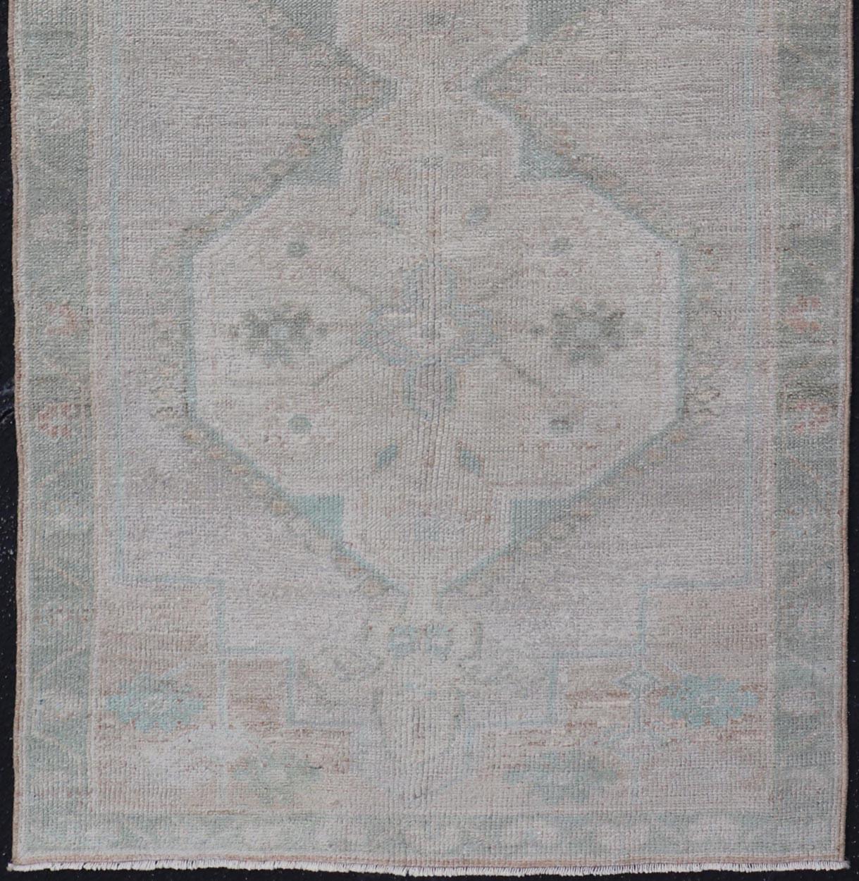 Wool Vintage Turkish Oushak Runner with Subdued Geometric Medallions in Light Tones For Sale