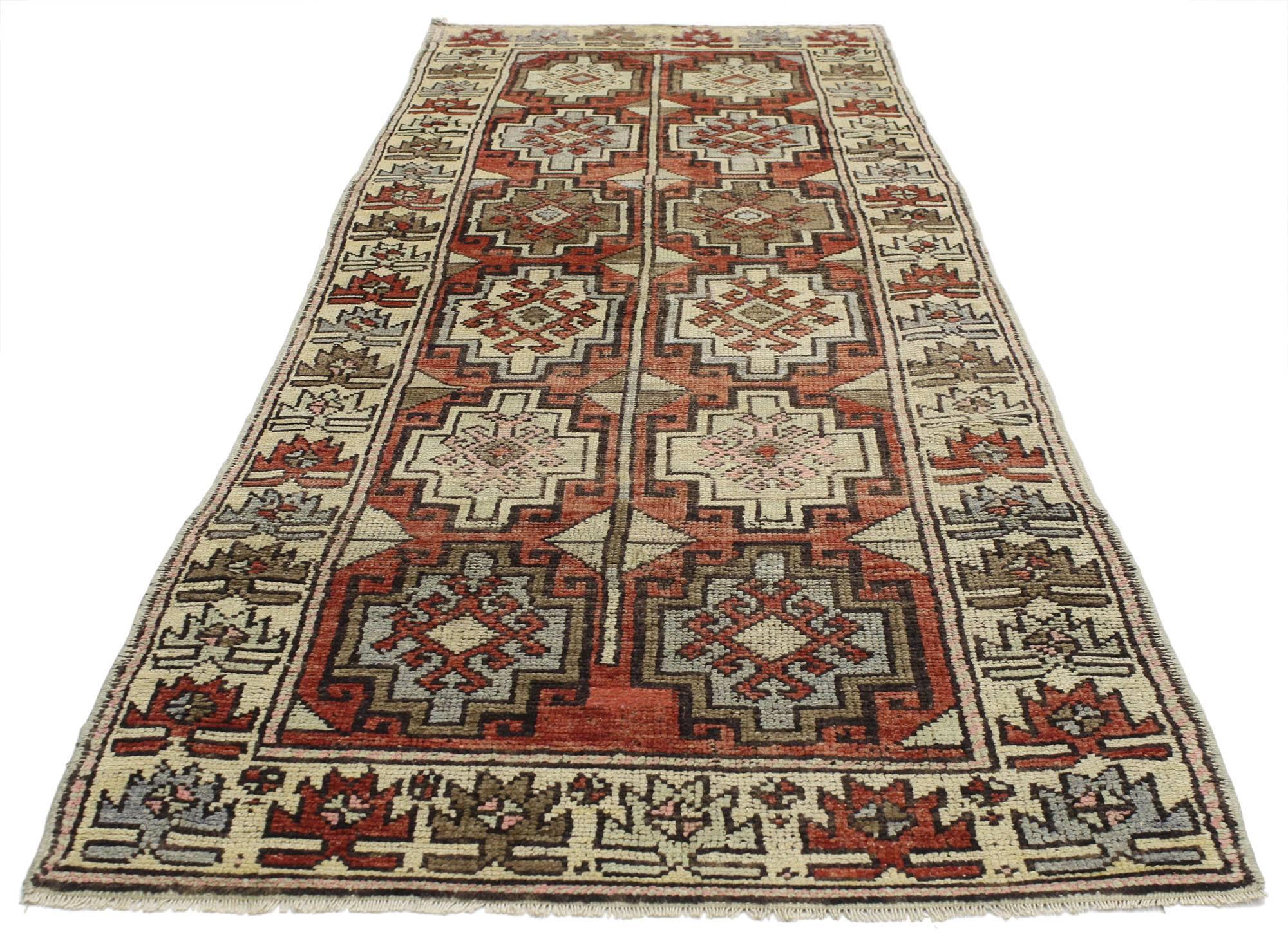 52255, vintage Turkish Oushak runner with traditional style. This hand-knotted wool vintage Turkish Oushak runner features two columns of six stair-step amulet medallions with latch-hook edges, enclosed in each medallion is a dragon motif for