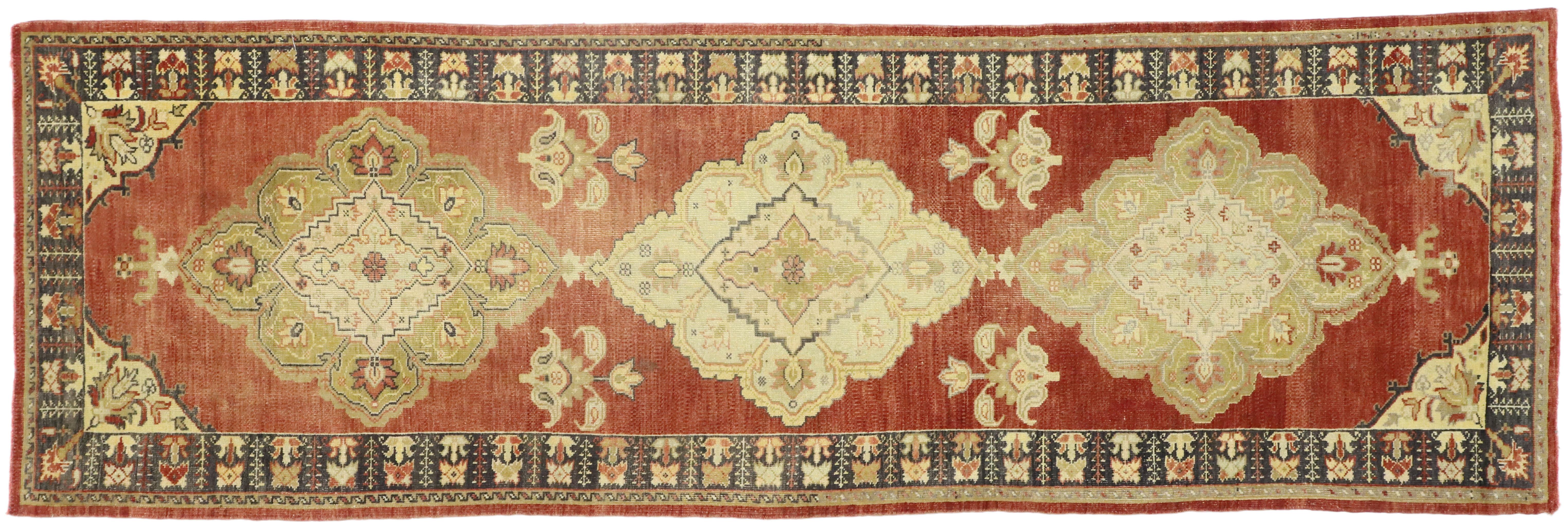 51660 Vintage Turkish Oushak Runner with Traditional Modern Rustic Style, Hallway Runner. This hand-knotted wool vintage Turkish Oushak runner features three diamond shaped medallions adorned with palmettes. The medallions rest on a field of
