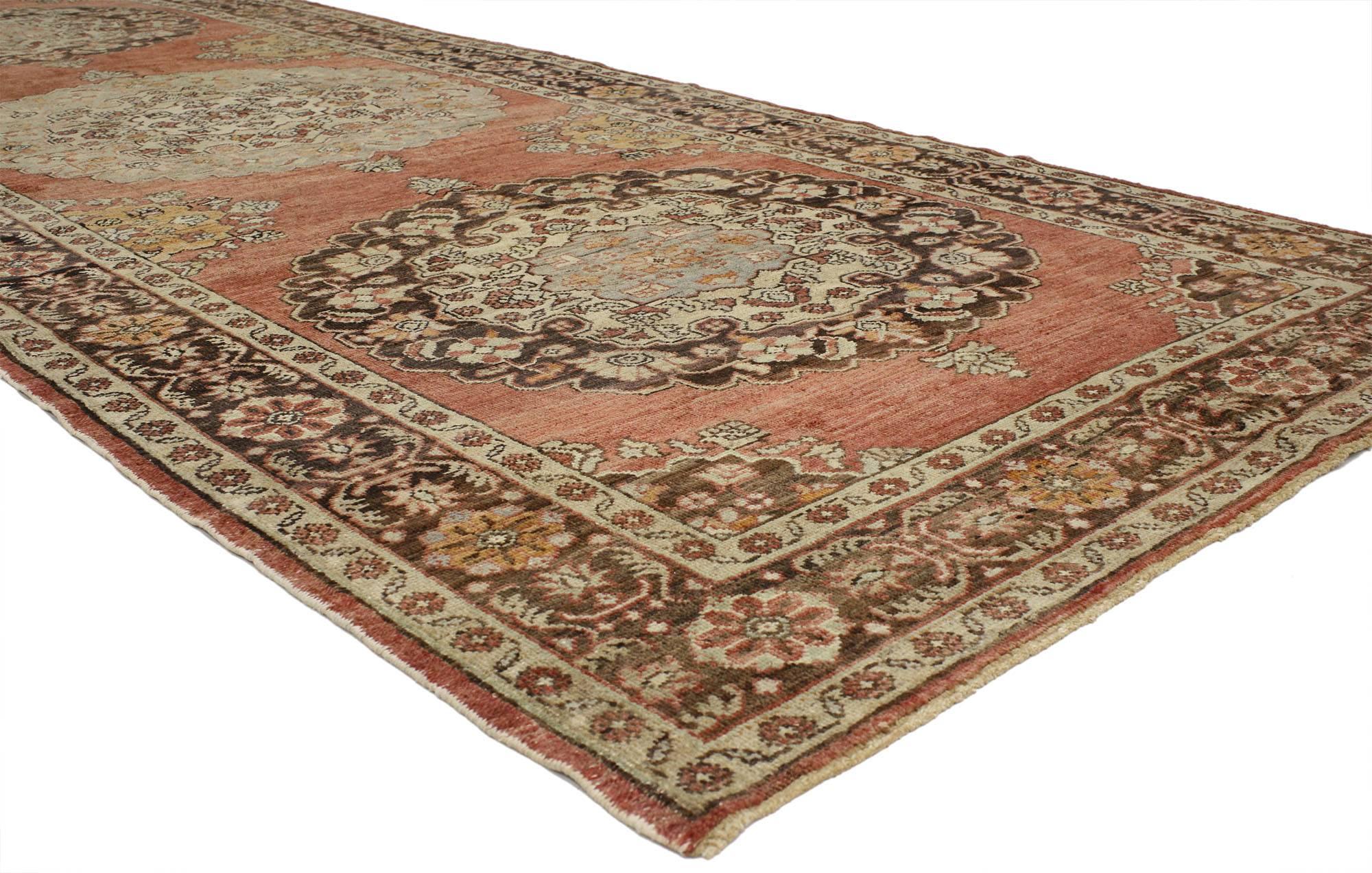 52248, vintage Turkish Oushak Gallery Rug with Traditional Style, Wide Hallway Runner 05'04 x 13'07. This hand-knotted wool vintage Turkish Oushak runner features a floral pattern with three circular medallions in an abrashed soft rustic red field.