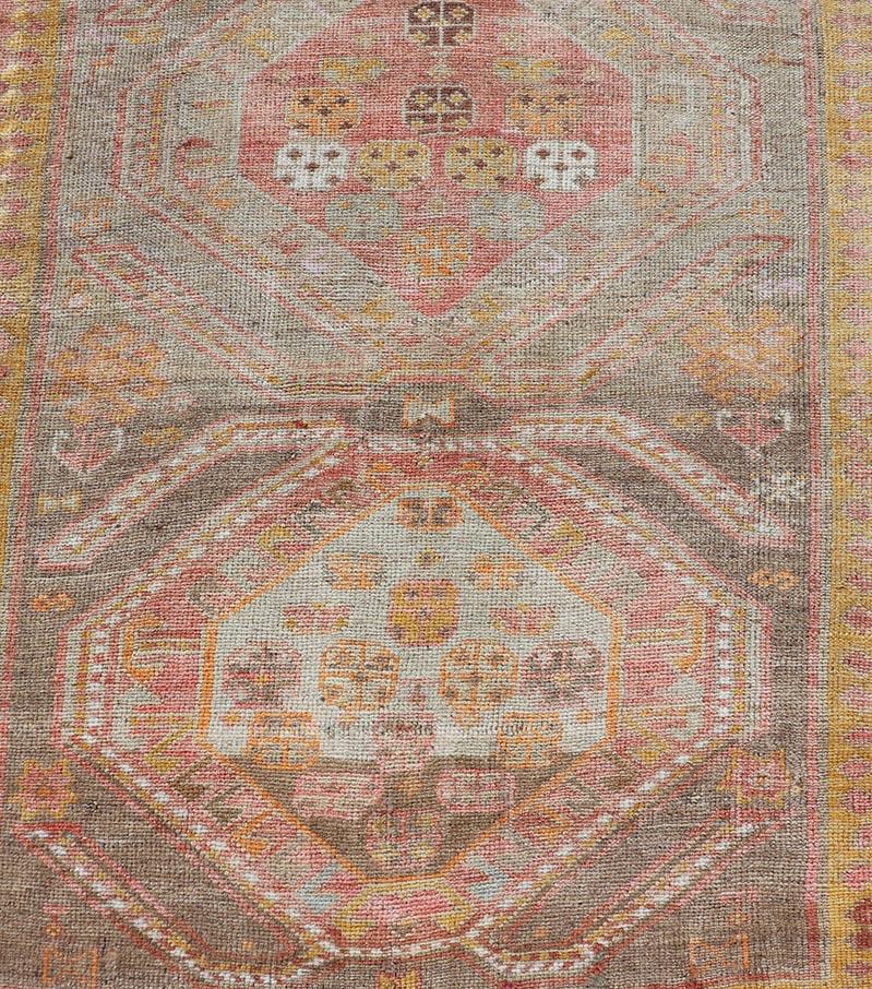 Measures: 2'11 x 10'11 
Vintage Turkish Oushak Runner with Tribal Medallions in Brown's, Yellow, and Red. Keivan Woven Arts / rug TU-MTU-936, country of origin / type: Turkey / Oushak, circa 1940.
This vintage Oushak runner features a unique blend