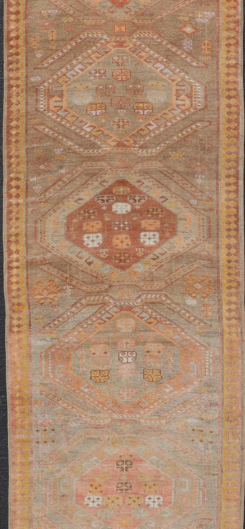 Vintage Turkish Oushak Runner with Tribal Medallions in Brown's, Yellow, and Red In Good Condition For Sale In Atlanta, GA