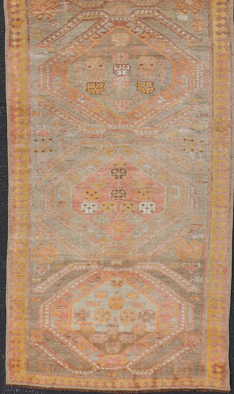 20th Century Vintage Turkish Oushak Runner with Tribal Medallions in Brown's, Yellow, and Red For Sale