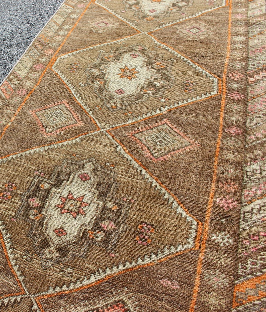 20th Century Vintage Turkish Oushak Runner with Tribal Medallions in Earthy Tones For Sale
