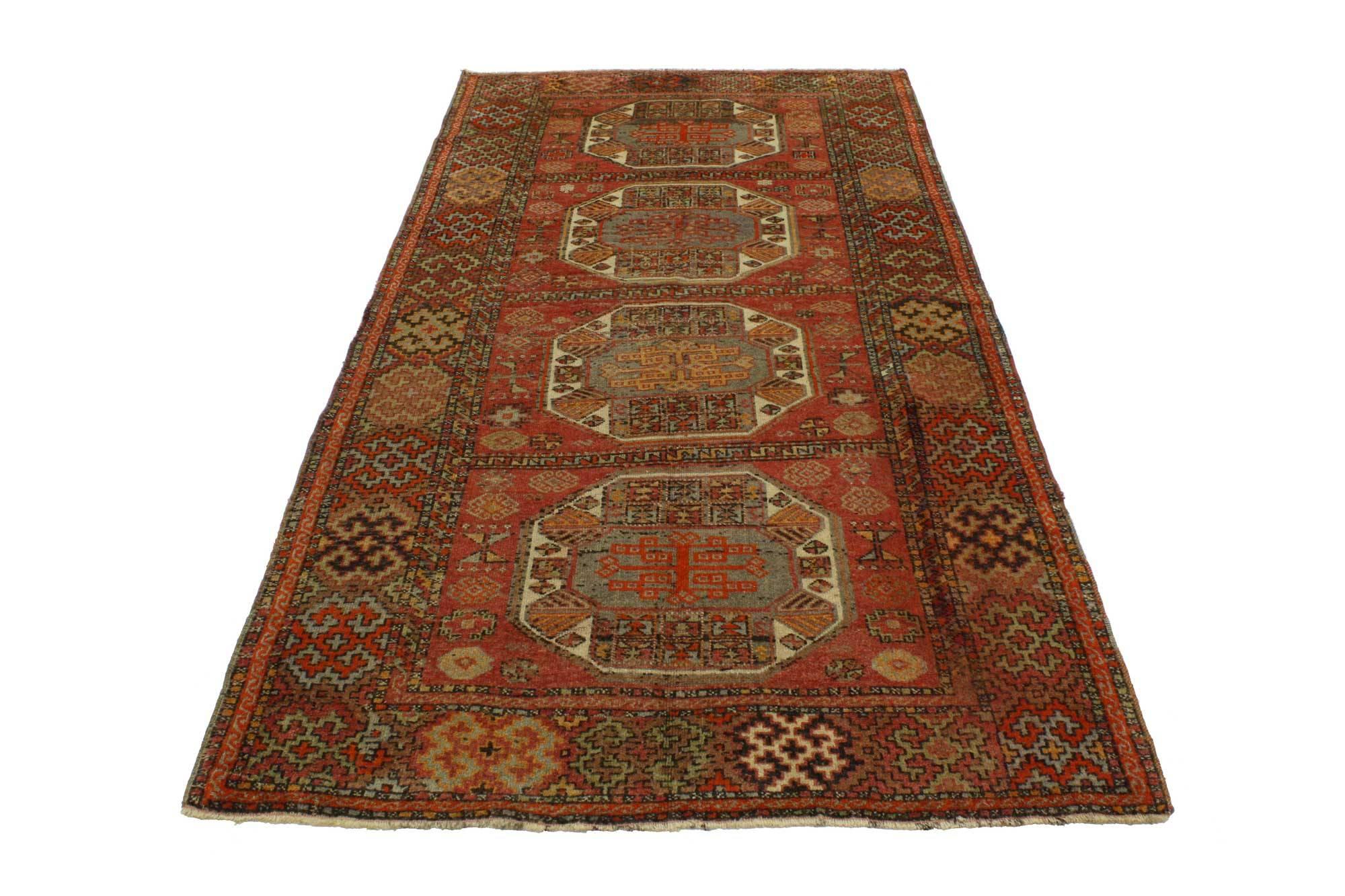 51677, vintage Turkish Oushak runner, hallway runner. This hand-knotted wool vintage Turkish Oushak runner with tribal style features four octagon medallions in separate compartments flanked with symbolic Turkish motifs in an abrashed red field. A