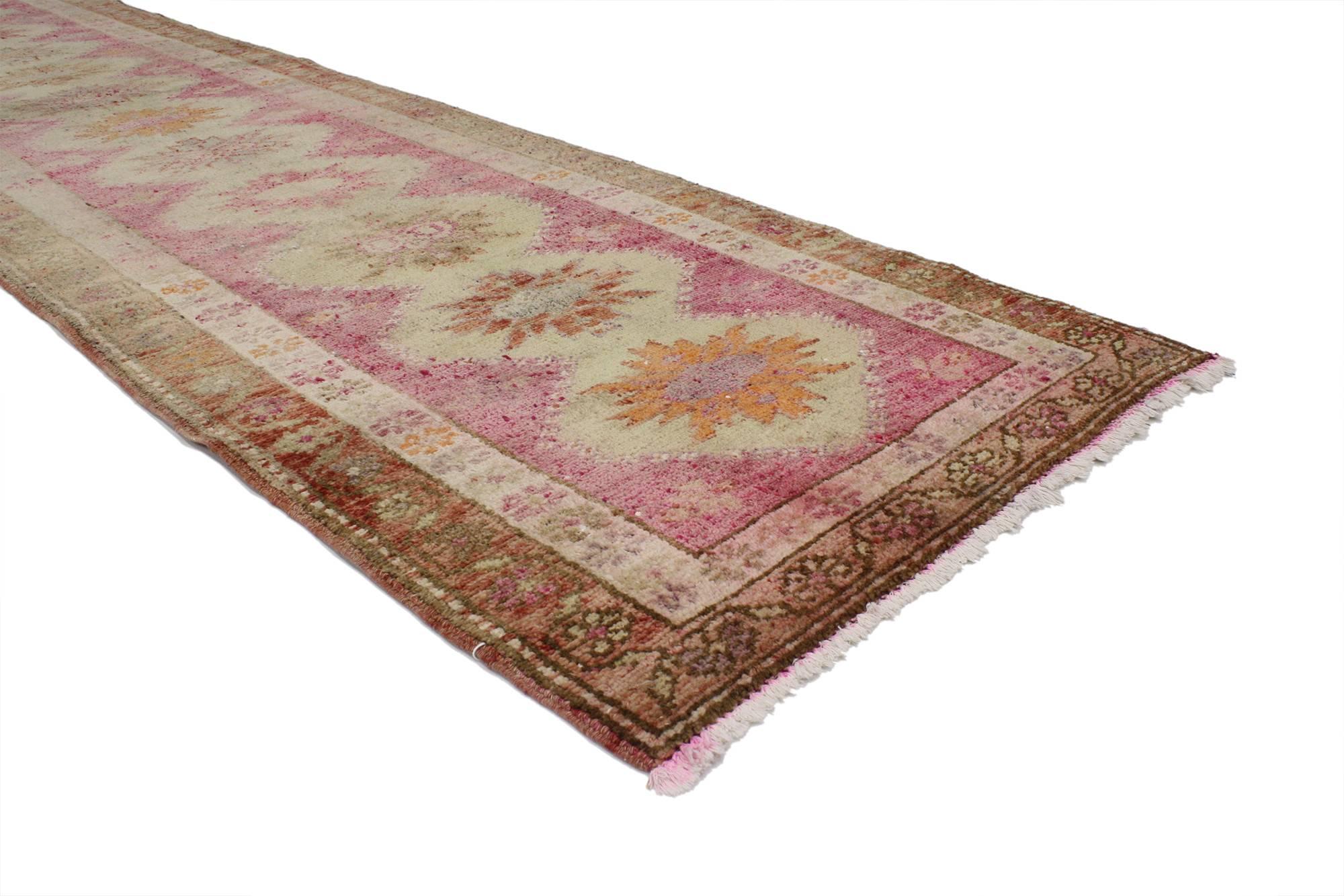52061, vintage Turkish Oushak runner hallway runner. This hand-knotted wool vintage Turkish Oushak runner with tribal style features a geometric pattern of stacked medallions in an abrashed field flanked with stylized flowers. A double border