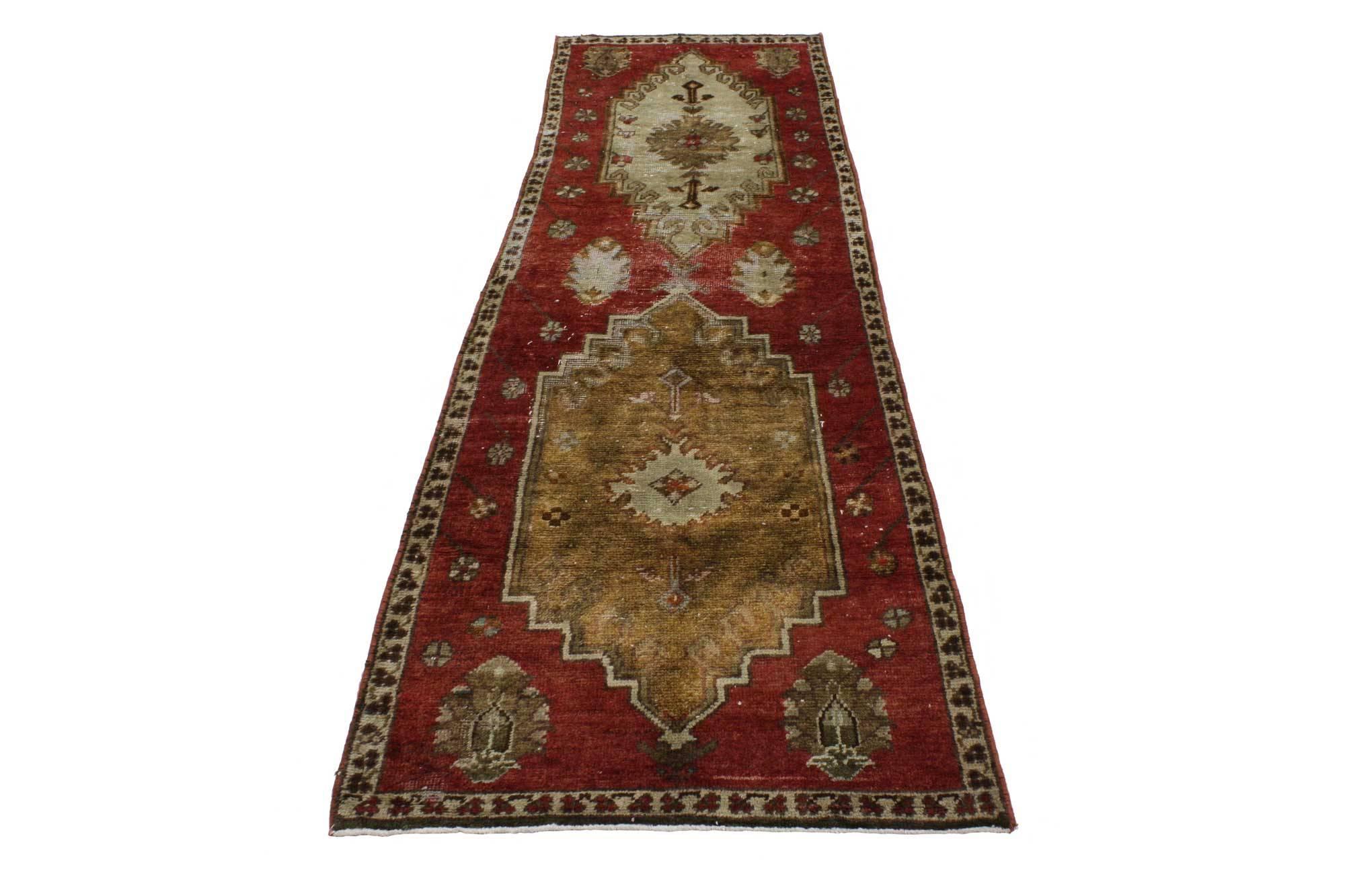 51676, vintage Turkish Oushak runner, hallway runner. This hand-knotted wool vintage Turkish Oushak runner features two stair-step medallions each filled with a Turkish flower flanked by two rods in a red field dotted with flowers. A thin border