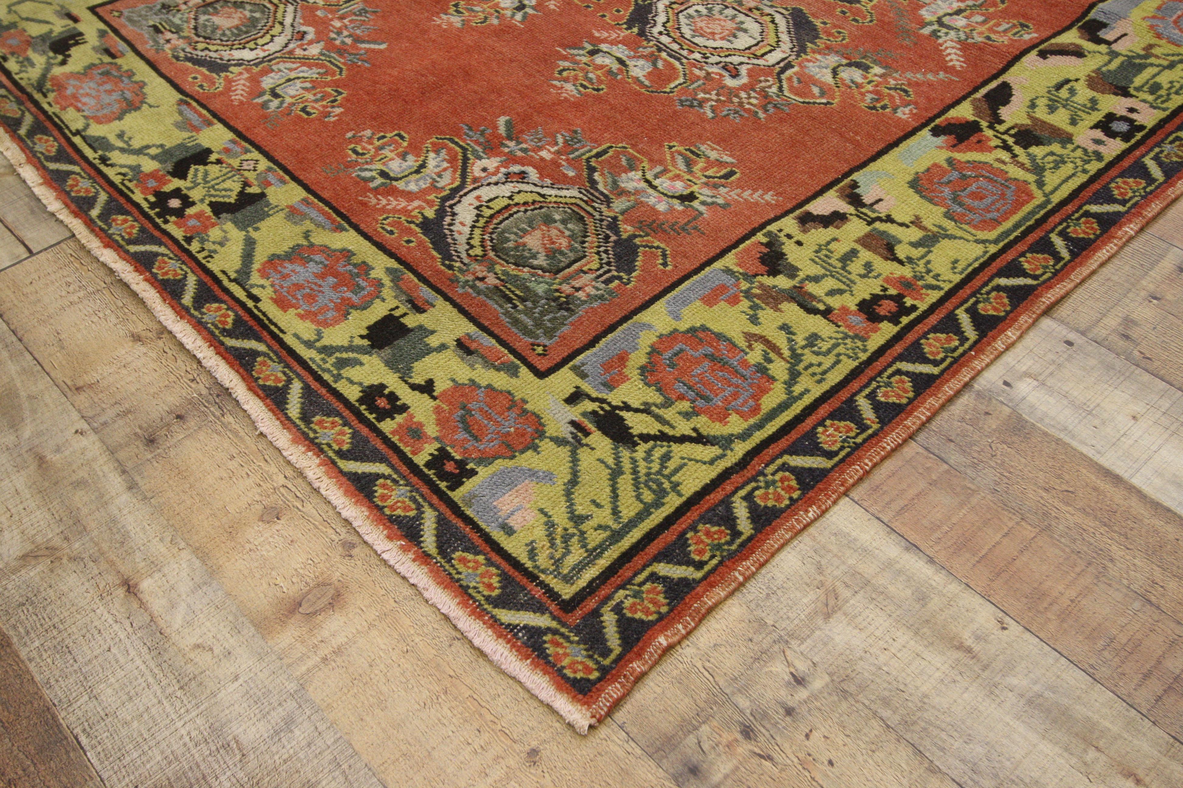 52392 vintage Turkish Oushak wide hallway runner with Art Deco Expressionist style . This hand knotted wool distressed vintage Turkish Oushak runner features large cabbage rose motifs arranged in quatrefoil bouquets spread across an abrashed field.