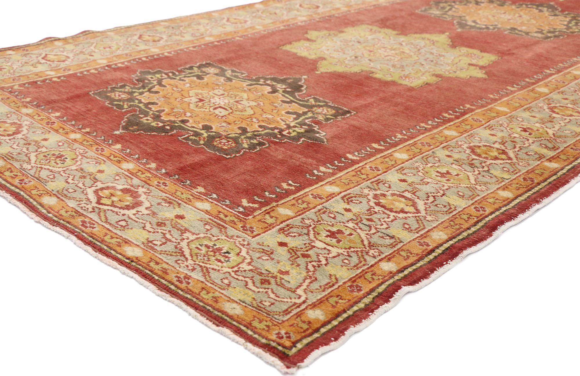 52502 Vintage Turkish Oushak Wide Hallway Runner with Spanish Revival Style 04'11 x 13'01. This hand-knotted wool vintage Turkish Oushak runner features five floral lobed medallions in alternating colors spread across an abrashed red field. Each