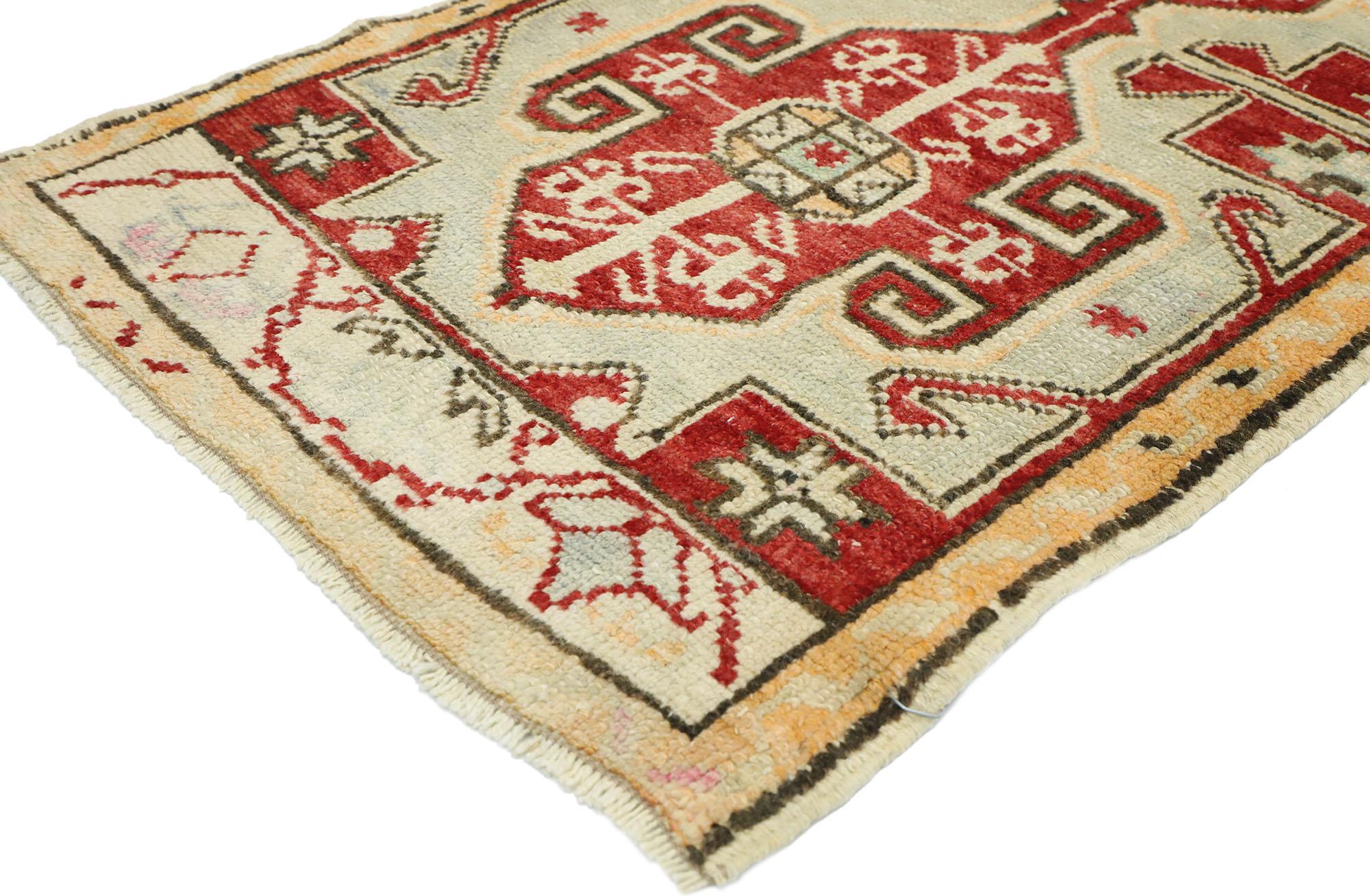 52691, vintage Turkish Oushak Yastik Scatter rug, small accent rug. This hand knotted wool vintage features two central medallions patterned with ram's Horn, hands on hips, eight-point stars, and latch-hooks on an abrashed field. It is enclosed with