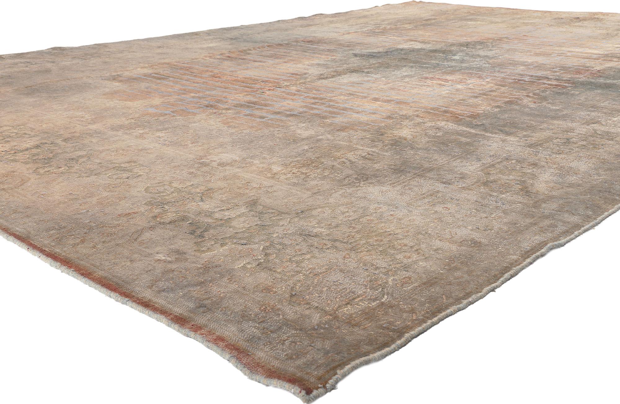 60621 Vintage Turkish Overdyed Rug, 09'09 x 14'03.
In the realm of design, the warm Industrial style gracefully intertwines with earth-tone elegance within the folds of this hand knotted wool vintage Turkish overdyed rug. A tapestry of nostalgia