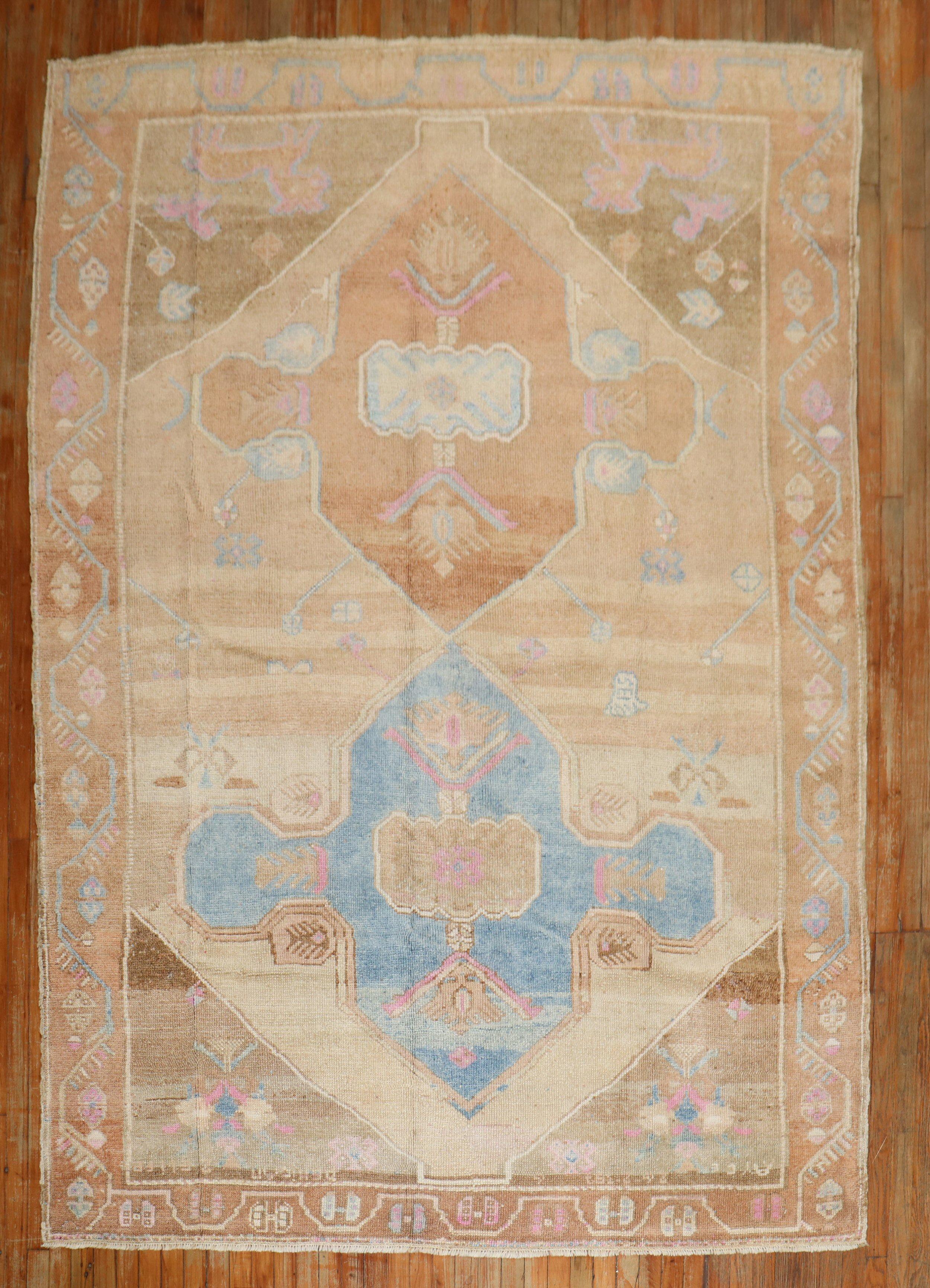 A room-size geometric Turkish kars rug from the 3rd quarter of the 20th century with 2 large brown medallions on a khaki ground, accents in sky blue , brown, and pink

Measures: 7' x 9'7