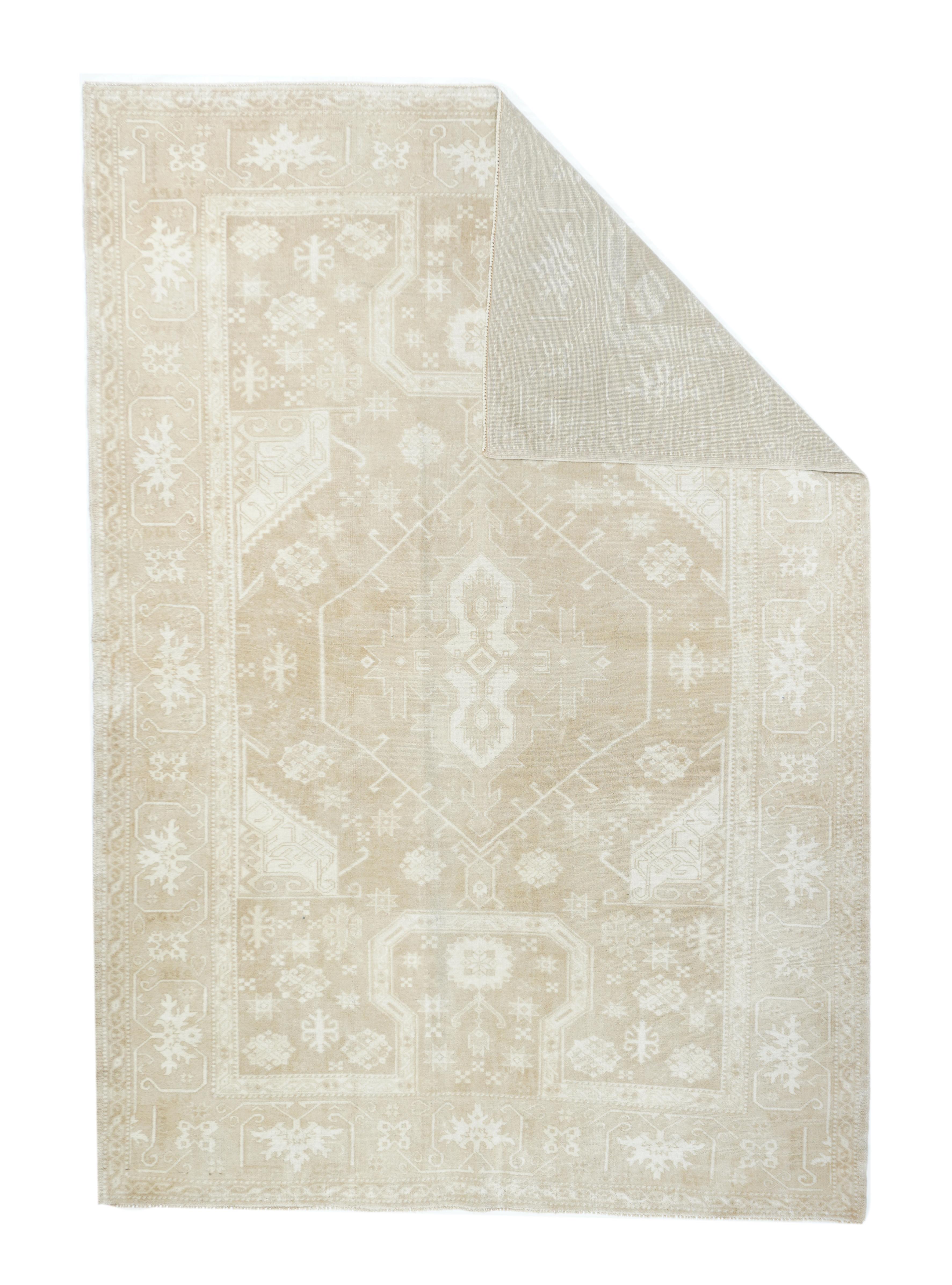 Vintage Turkish Rug 5'3'' x 7'8''. This Vintage Anatolian scatter shows cloud band-shaped “re-entrants” at the ends of the field in the 16th-17th century manner, with a central, sparsely hooked hexagon, and fractional similar side fillers, on a