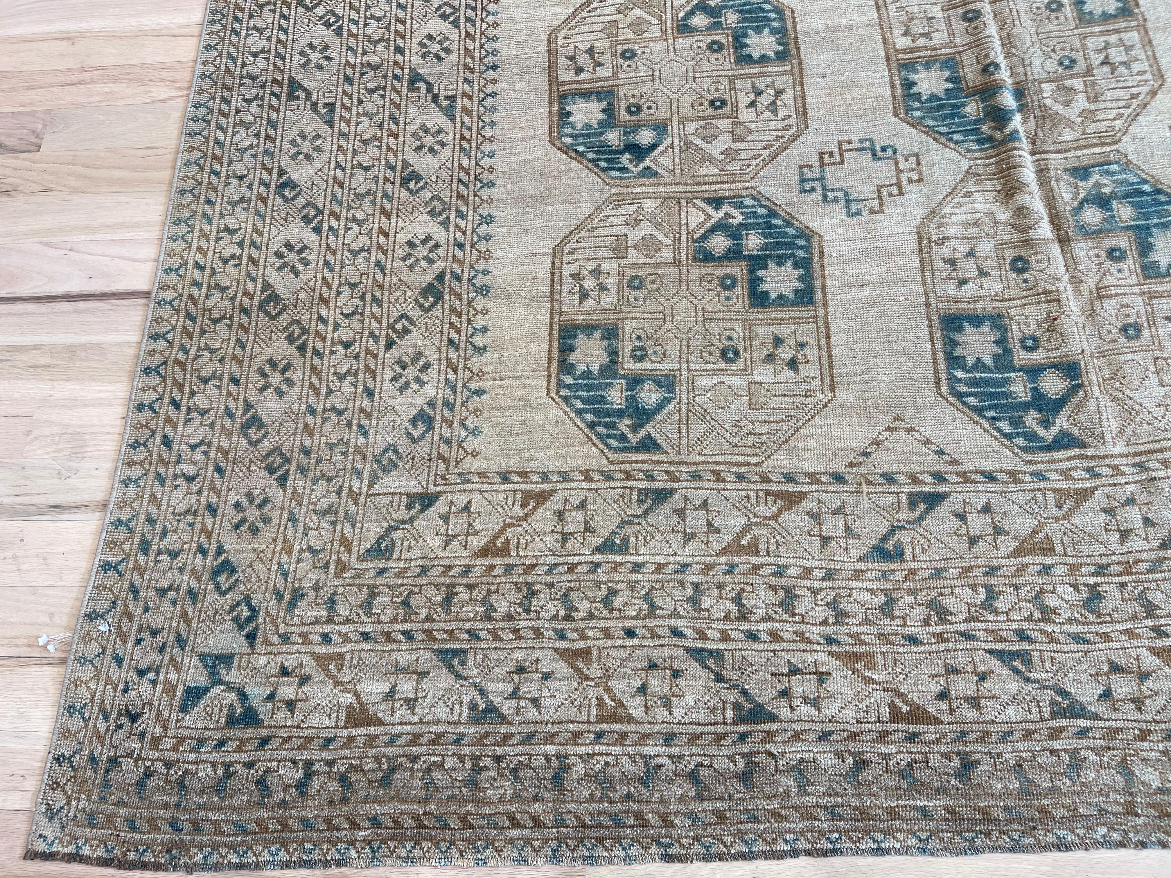 Vintage meets modern with this stunning Turkish rug. 
Made entirely from wool, its deep hues of blues and browns will add warmth and sophistication to any room. 
Enjoy the timeless elegance and durability of this one-of-a-kind piece.