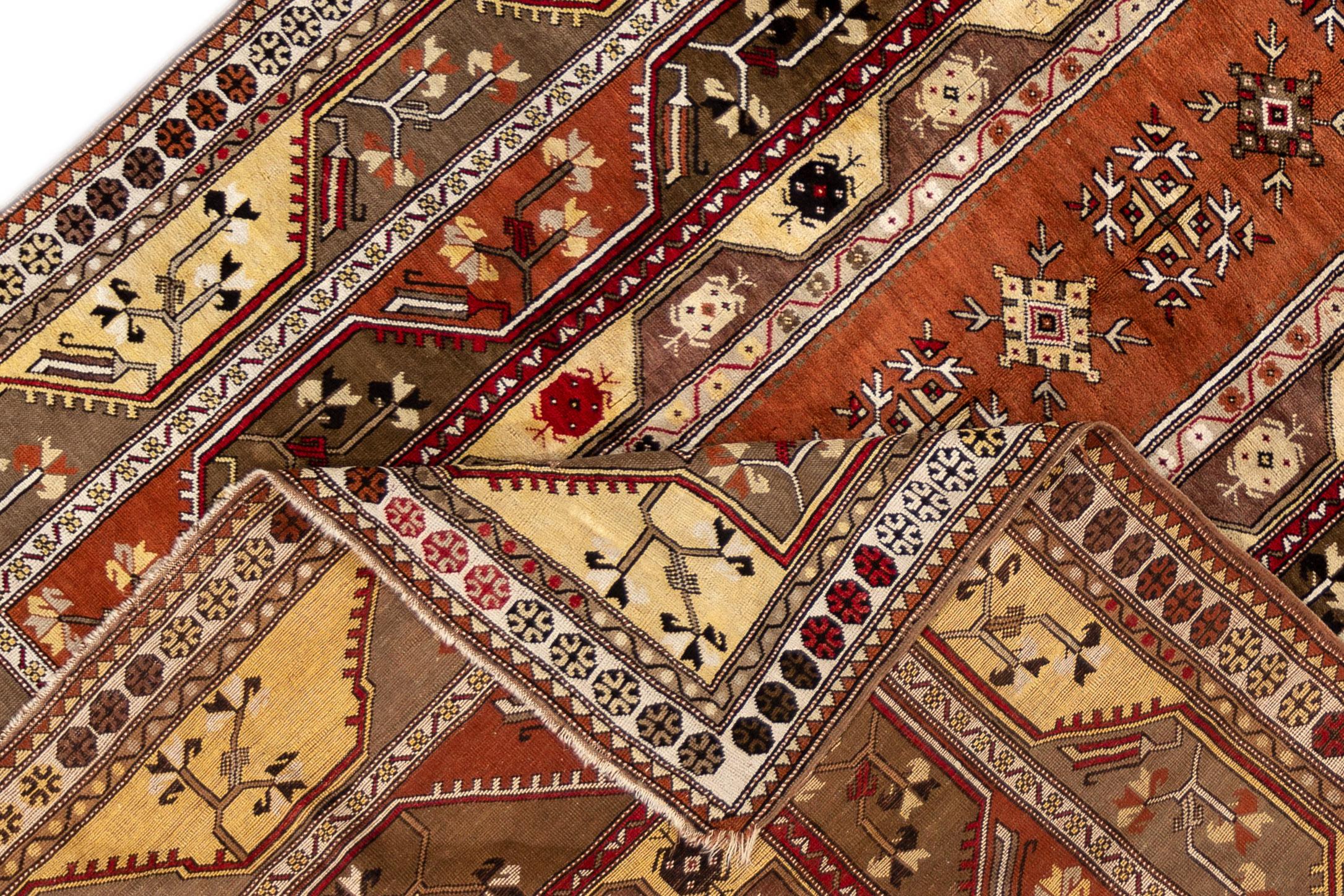 A vintage Turkish hand knotted wool rug with a rust-colored field and all-over geometric design. This rug measures 6'8