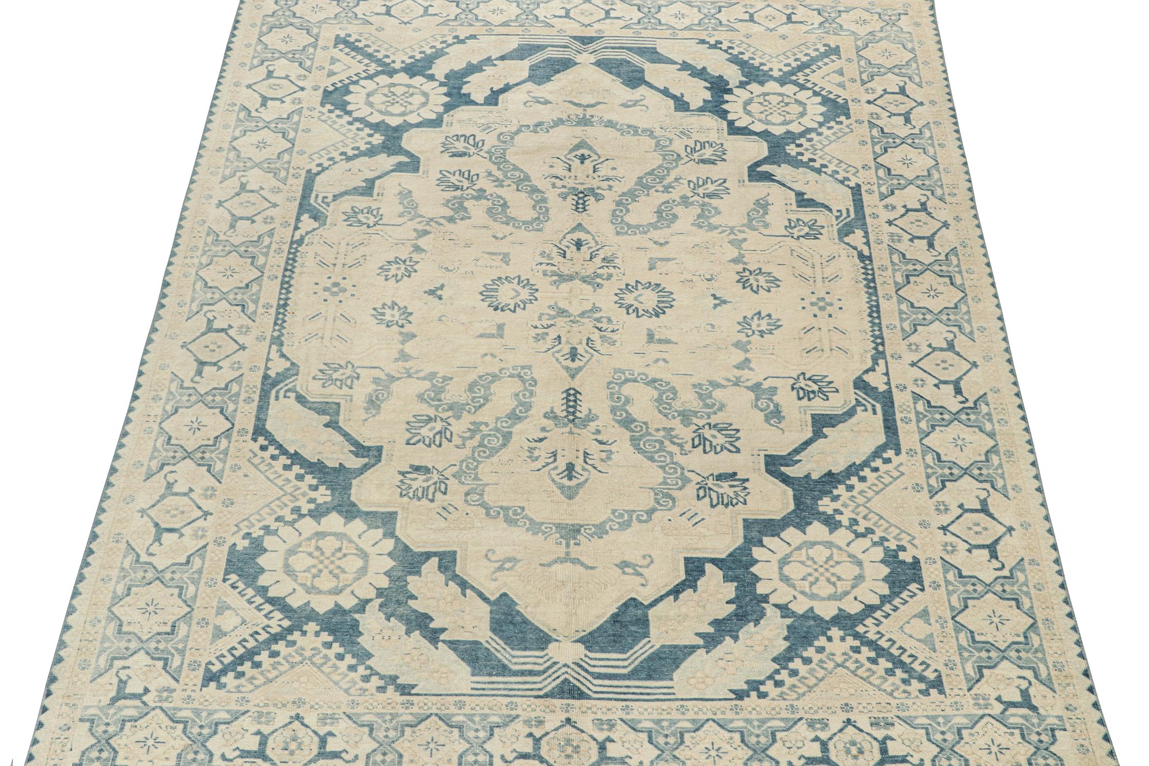 This vintage 7x10 rug is hand-knotted in wool, and originates from Turkey, circa 1950-1960. 

Its design features subtle inspirations from antique Persian rugs, uniquely reimagined in these forgiving colors. Both the field and border host elegant
