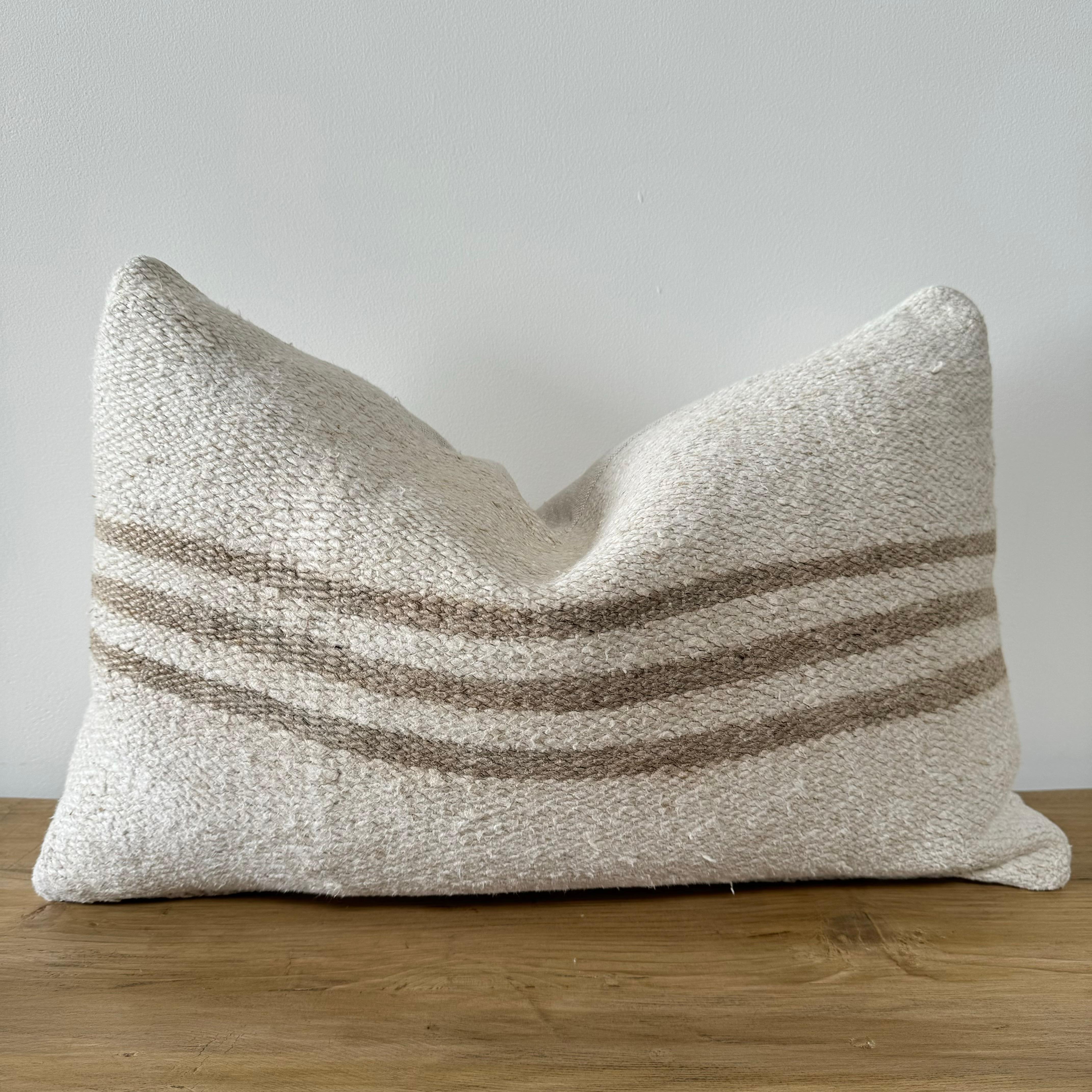 Vintage RUG PILLOW
Unique pillow has been made with a turkish rug, in multiple white tones, and some variations of white woven through with stripes. The face is fully lined, with a coordinating backing in a linen fabric, and hidden zipper