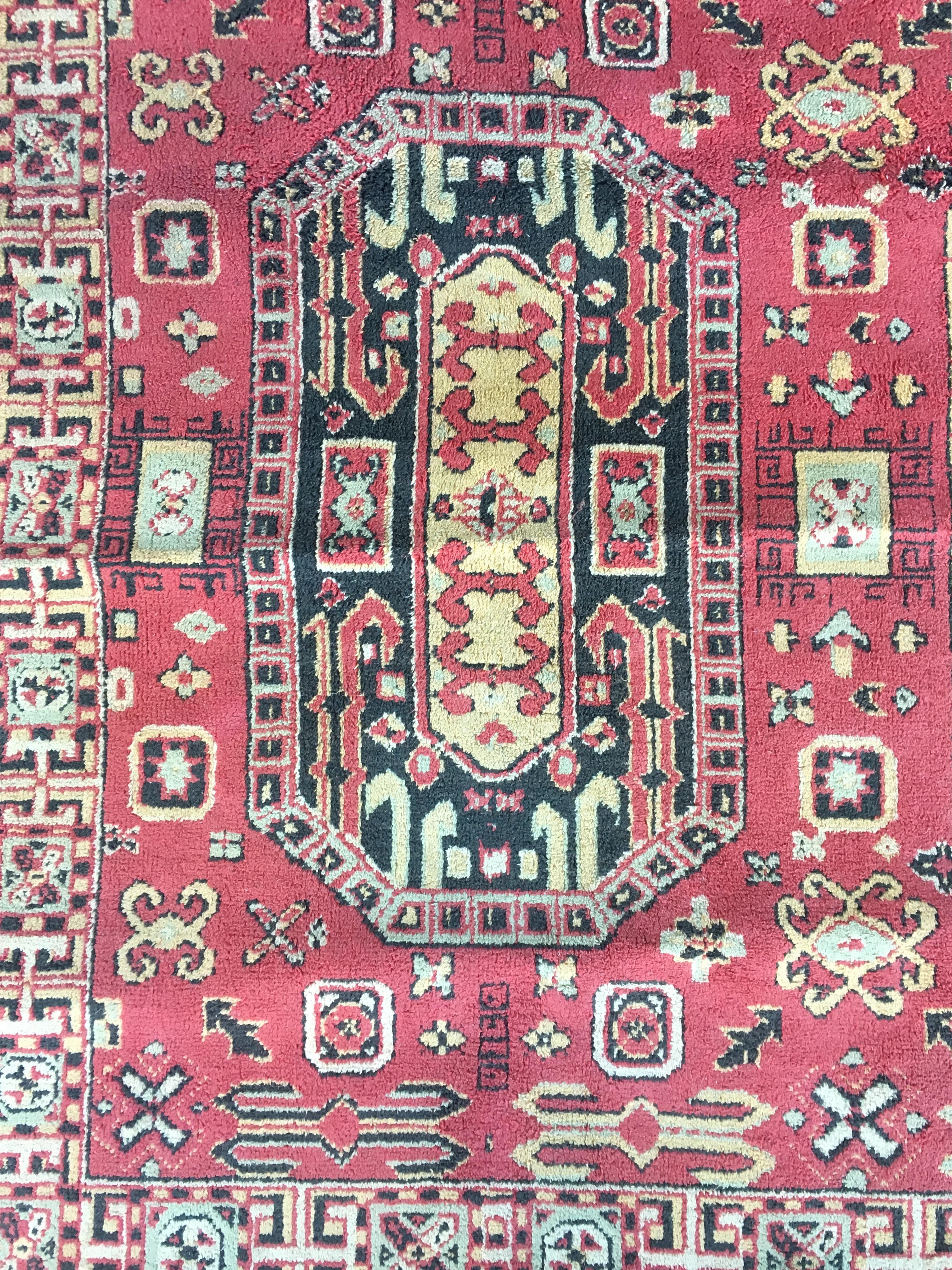 A beautiful throw rug from the early 20th century.

Rendered in variegated shades of ruby red, brass, saffron, coffee, pistachio, sage, gray and beige. Perfect for anywhere: Entry, hall, stair landing, hallway, kitchen, corridor, living room,
