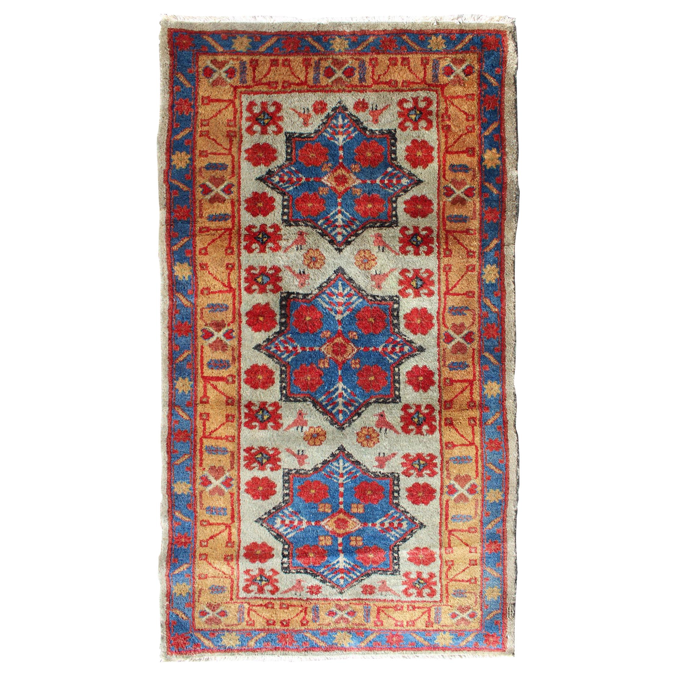 Tapis turc vintage avec motif d'étoiles en vert clair, orange, rouge et bleu  