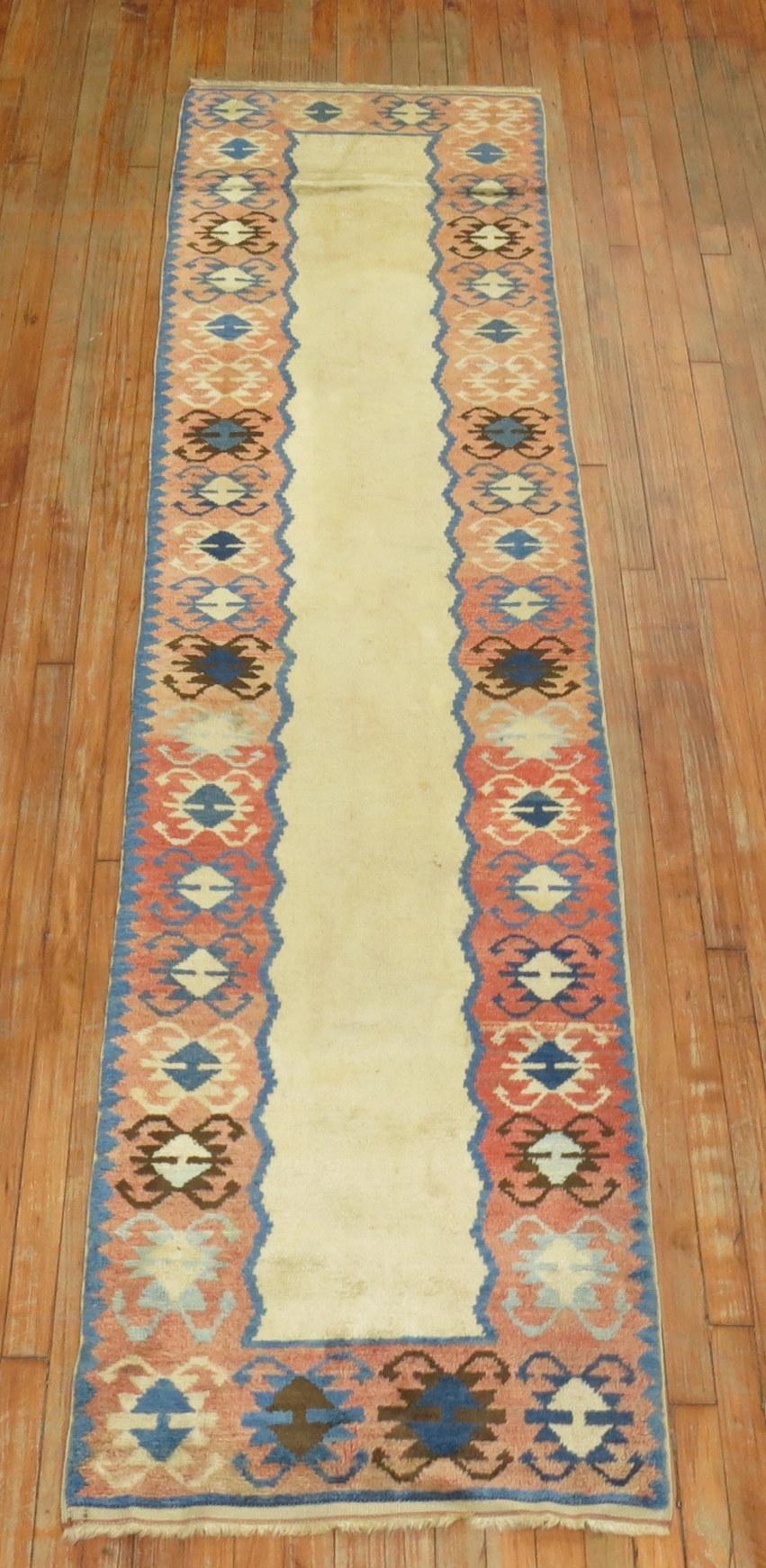 A narrow runner mid-20th century Turkish runner resembling American Navajo rugs.
