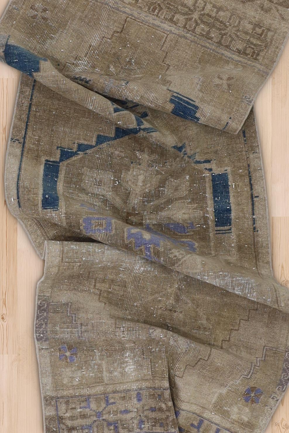 Age: Circa 1950

Colors: dark tan, taupe, blue, lavender 

Pile: low

Wear Notes: 7

Material: Wool on Cotton. 

Moody vintage Anatolian runner with lovely texture and interesting abrash.

Vintage rugs are made by hand over the course of months,