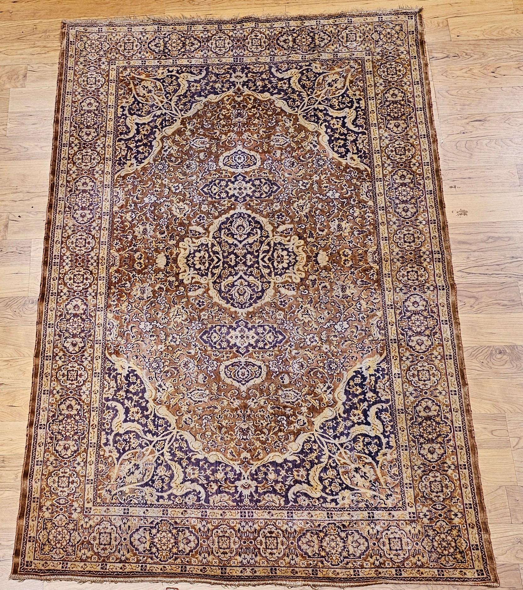 Add timeless elegance to your space with this beautifully crafted mid-20th century Turkish silk area rug. Machine-woven with exceptional precision, this piece showcases a delicate floral medallion design, set against a rich brown background with