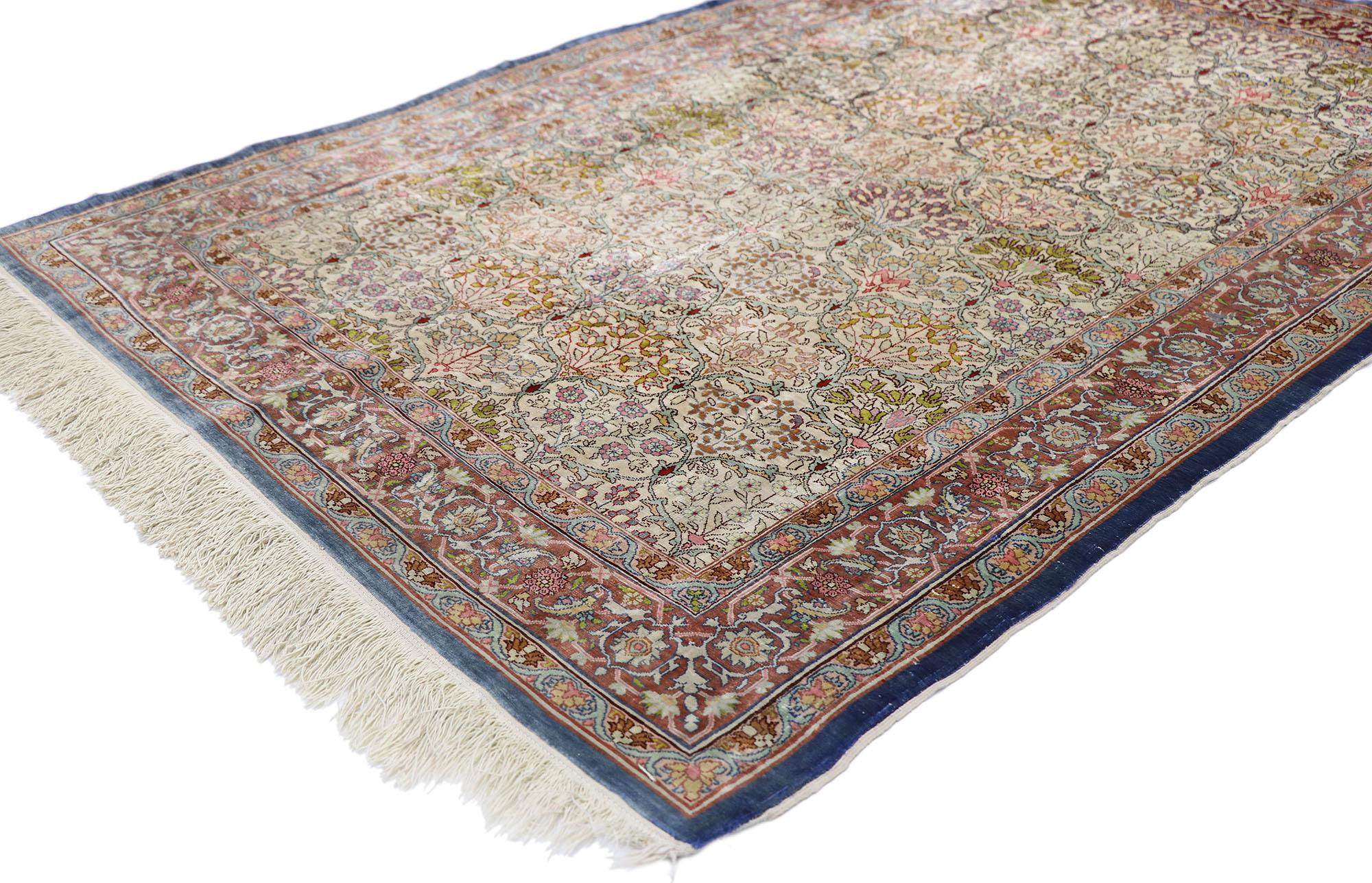 77795, vintage Turkish silk Hereke rug with Art Nouveau Rococo style. Give the look of woven wonders and warmth with this hand knotted vintage Turkish silk Hereke rug. The abrashed beige field features an all-over botanical millefleur trellis