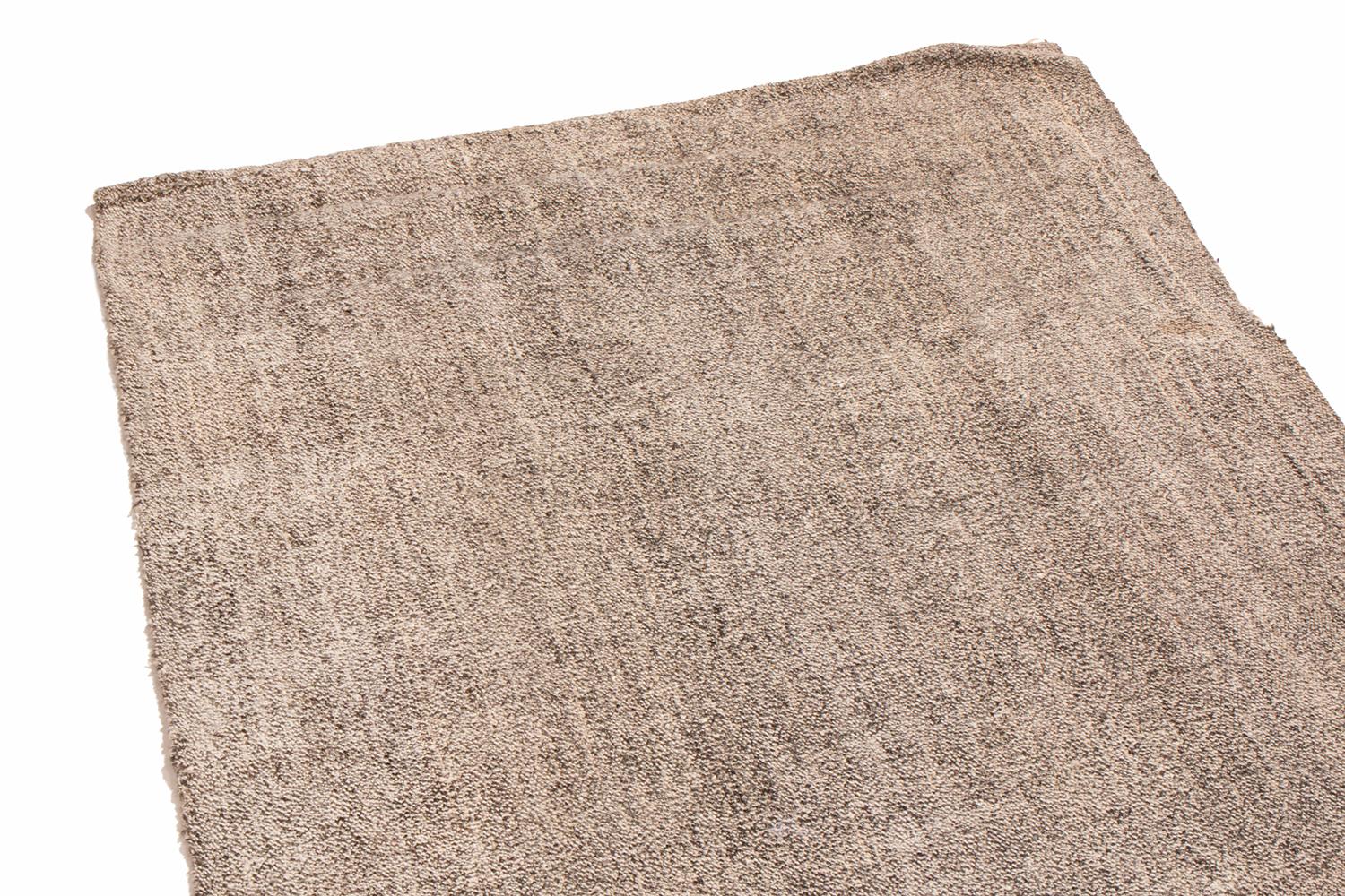 Originating from Turkey in 1960, this vintage wool Kilim runner is flat-woven in high quality wool with subtly rectilinear, vertically oriented abrash of Industrial and metallic gray and silver colorways.
  