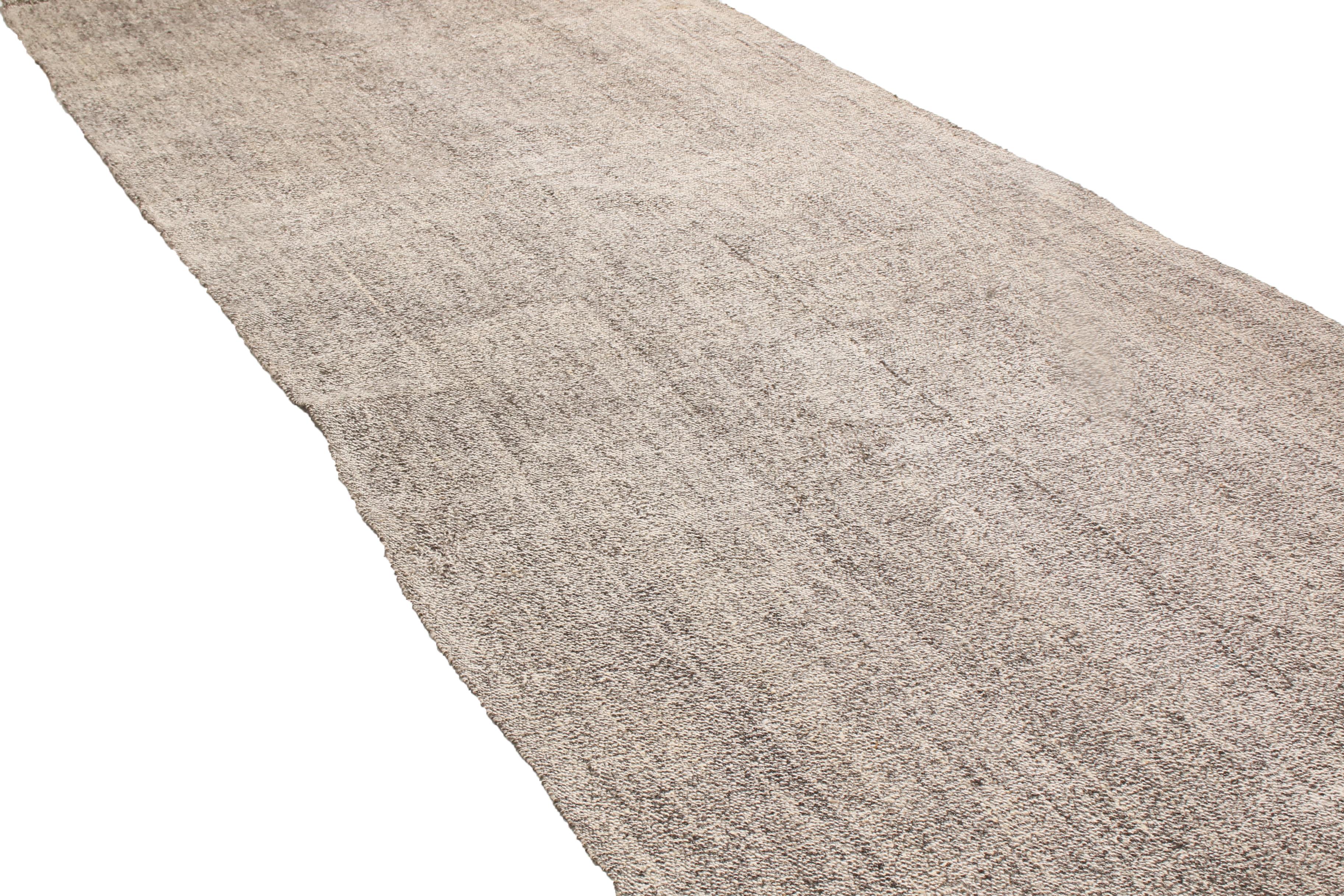 Originating from Turkey in 1960, this vintage wool Kilim runner is flat-woven in high quality wool with subtly rectilinear, vertically oriented abrash of Industrial and metallic gray and silver colorways.
 