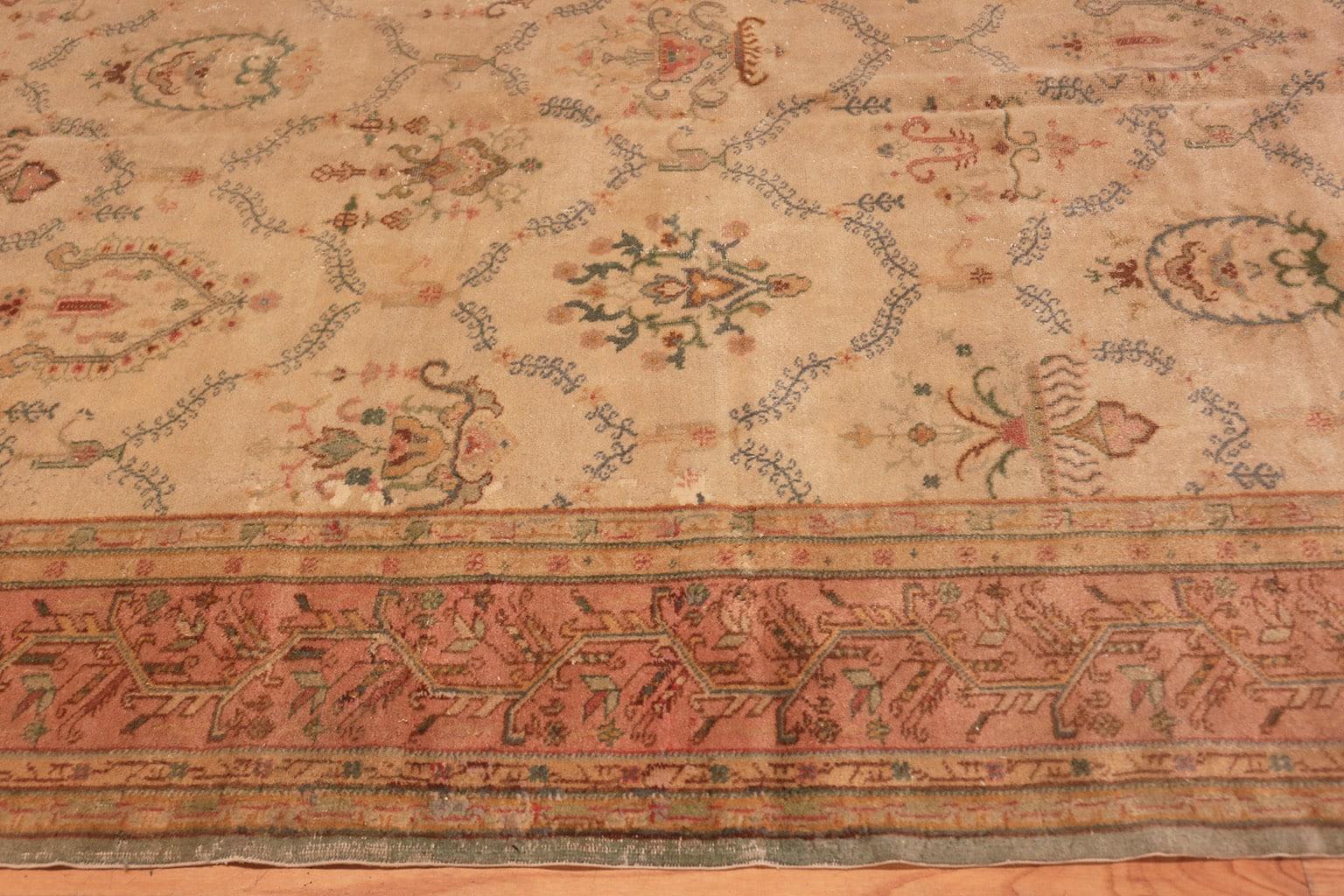 Vintage Sivas carpet, origin: Turkey, circa mid-20th century - Size: 11 ft 9 in x 17 ft 3 in (3.58 m x 5.26 m). 

A rich, grapefruit pink border surrounds the Sivas carpet, its interior containing a pleasantly curling vine that establishes an almost