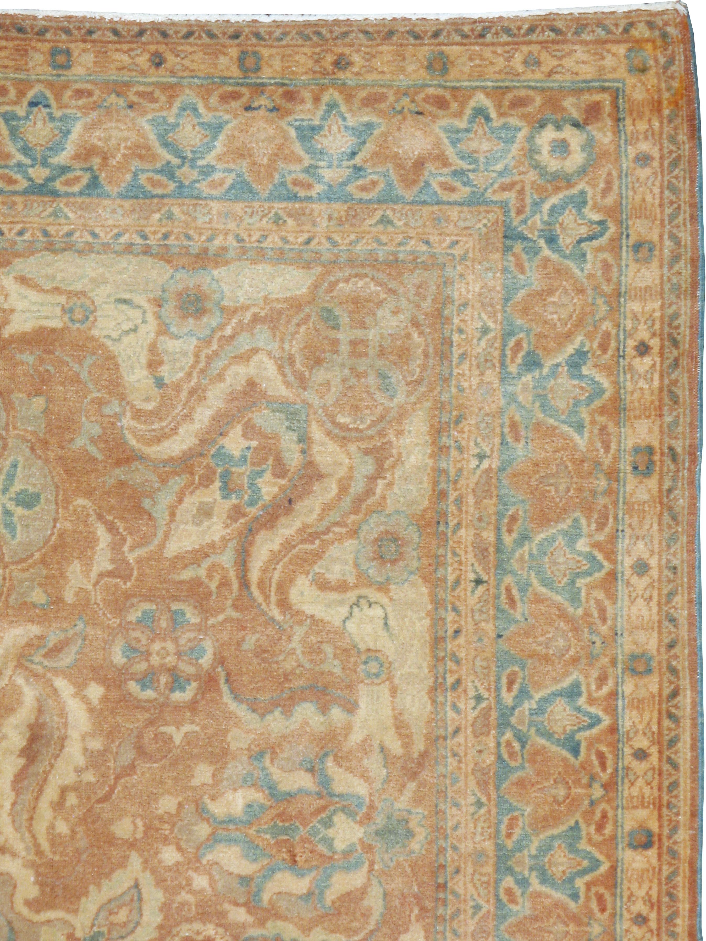 A vintage Turkish Sivas rug from the mid-20th century. This mellow colored Sivas has a medallion and bold leaf pattern on a light rust ground. The corners flow in a particularly dramatic manner in this accent rug sized perfectly for a coffee table