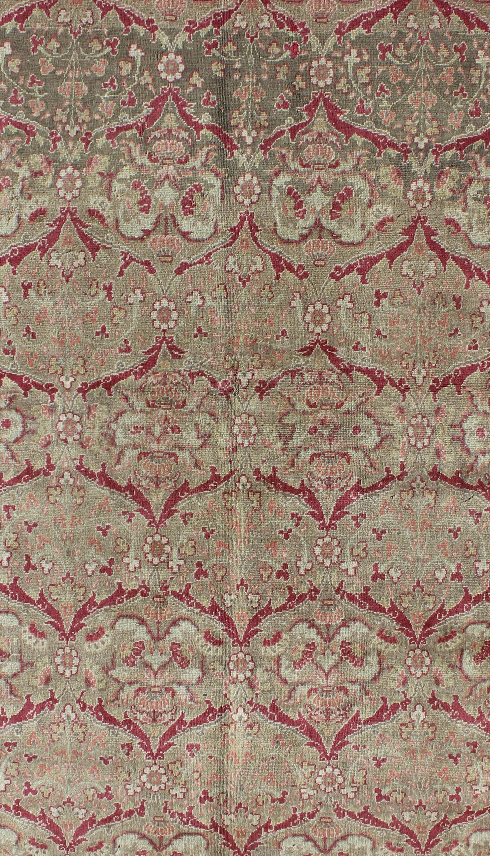 Measures: 5'0'' x 7'7''.

In this antique Sivas piece, a traditional all-over pattern is reinterpreted with a subtle arabesque aesthetic. Vinery, floral designs, and leaping blossom motifs are featured in a muted palette of taupe, red, and soft