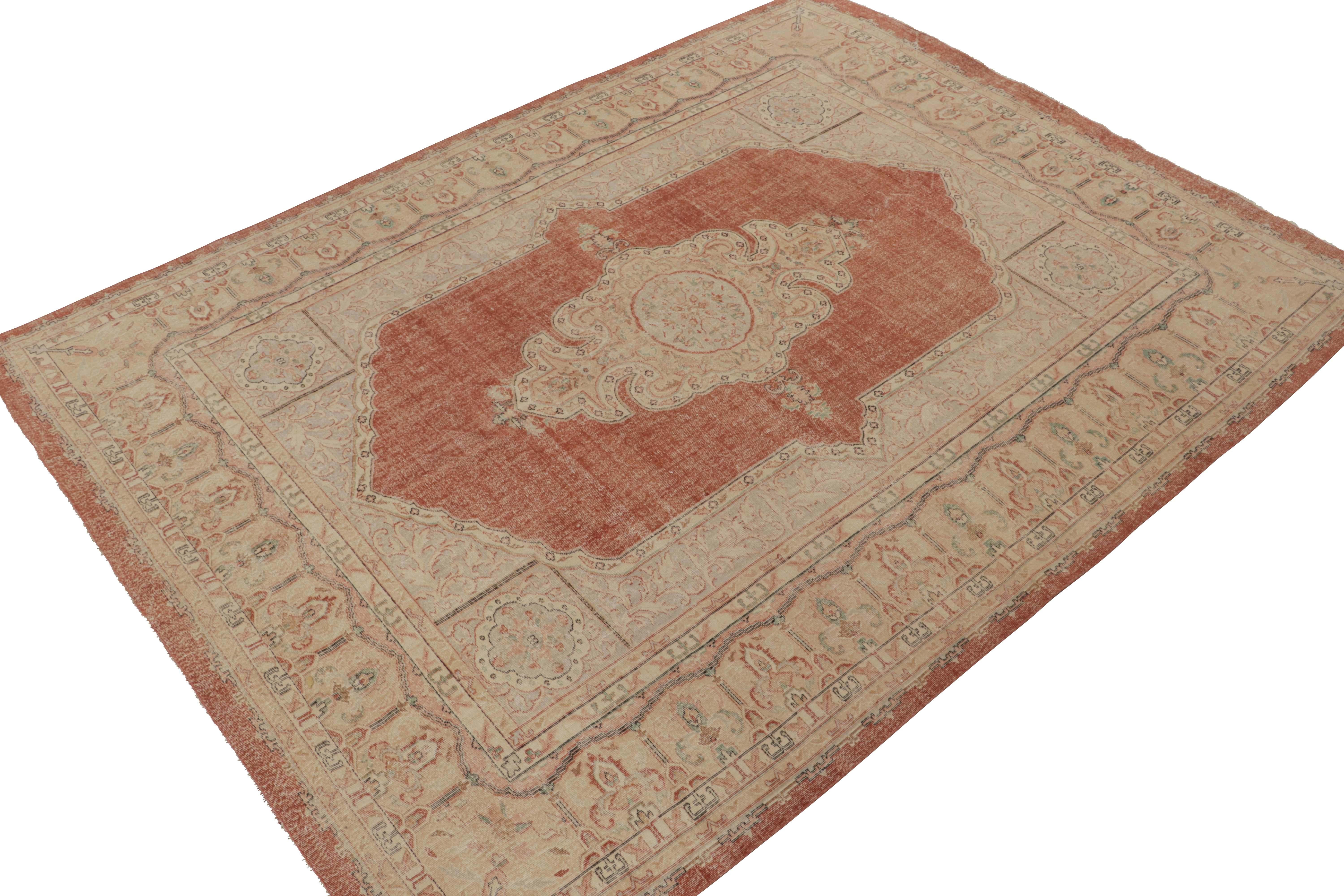 From Rug & Kilim’s classic Turkish selections, a 9x12 vintage Sivas rug, hand-knotted in wool circa 1950-1960. This gorgeous piece depicts an elegant floral medallion pattern in pink with beige and blue atop a beautiful rust red backdrop. Keen eyes