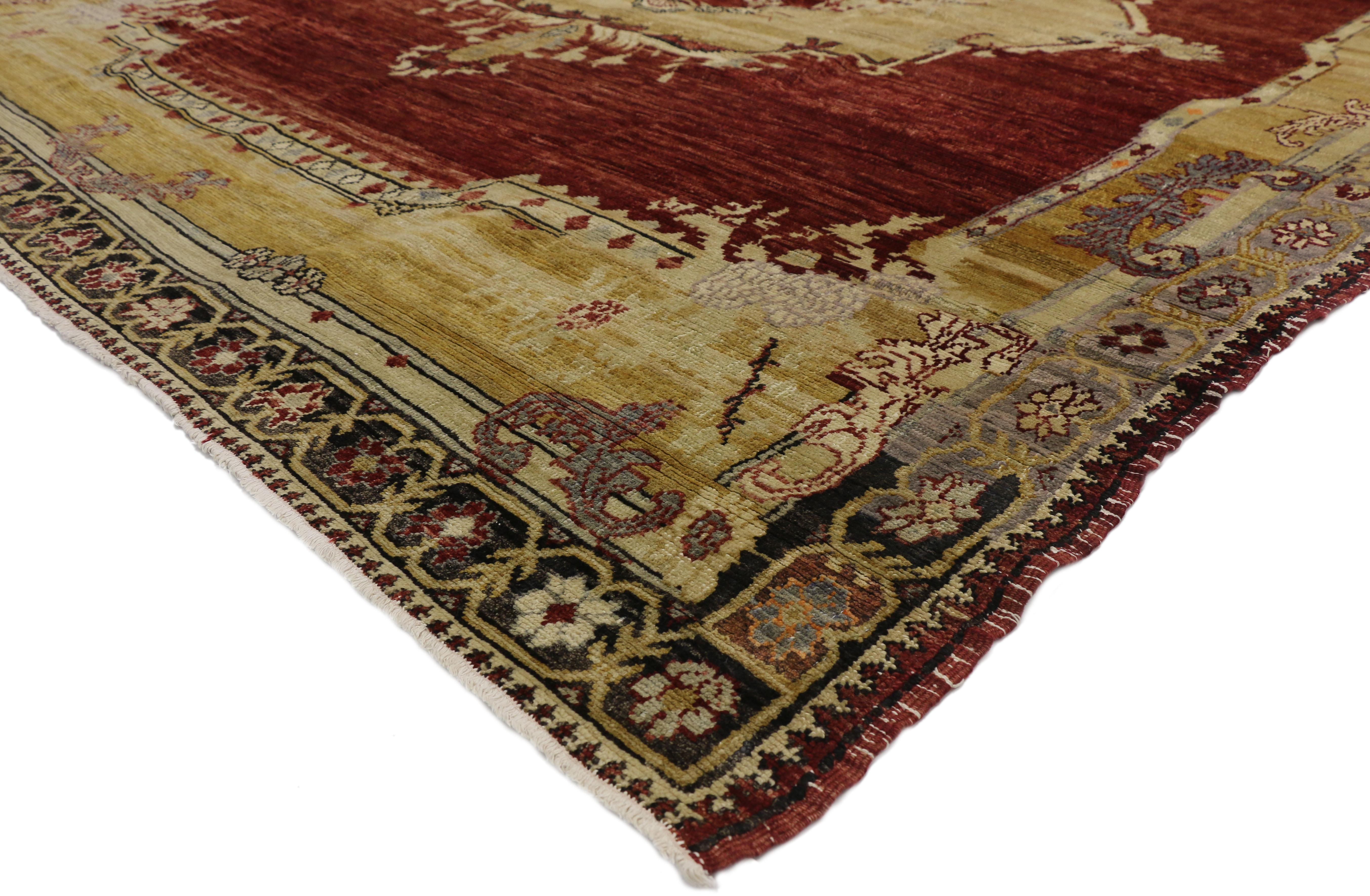 50650 Vintage Turkish Sivas rug with Byzantine and Gothic Revival style. This hand knotted wool features a grandeur central medallion floating in a robust sea of abrash. Each corner spandrel beautifully displays pomegranates and leafy tendrils