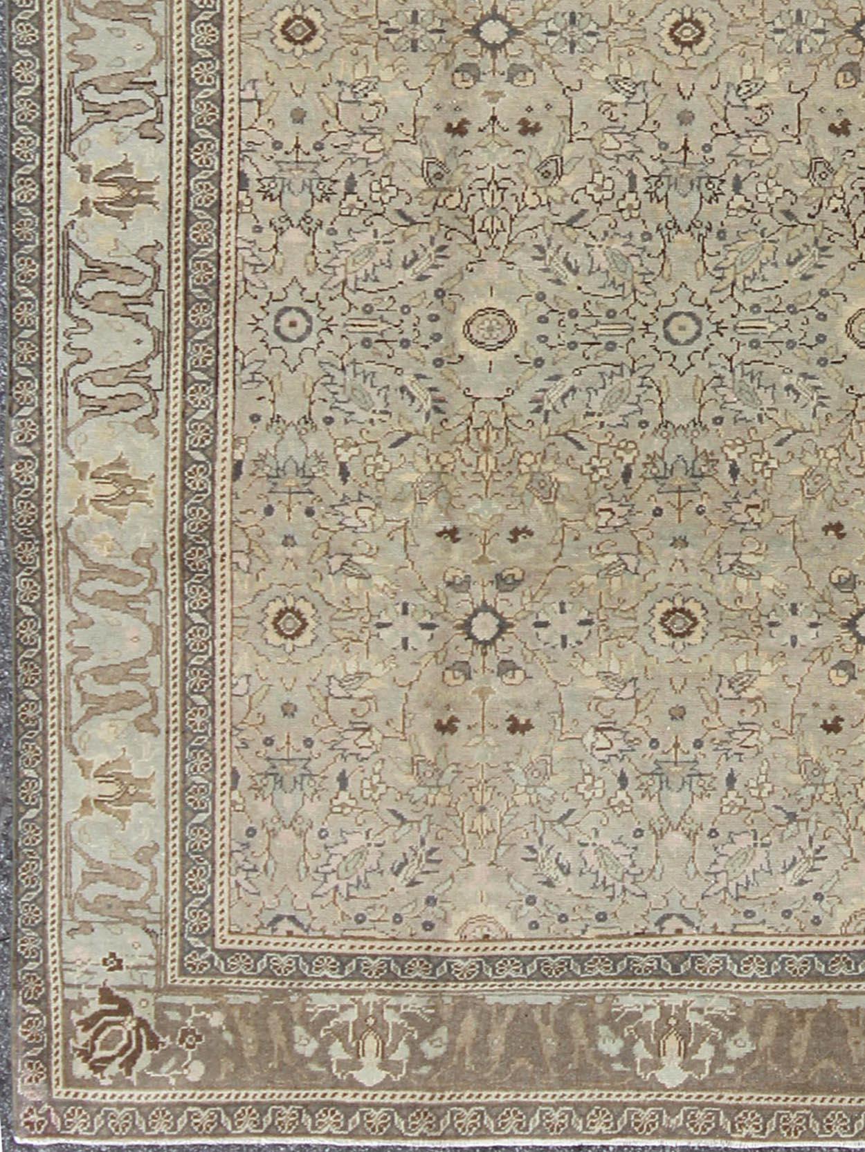 Measures: 5'9' x 8'2'

In this early 20th century Turkish Sivas antique rug, the sand field features a delicate trellis design of scrolling vinery and scattered fleuron within a spacious sand-colored palmette and fleuron border. These