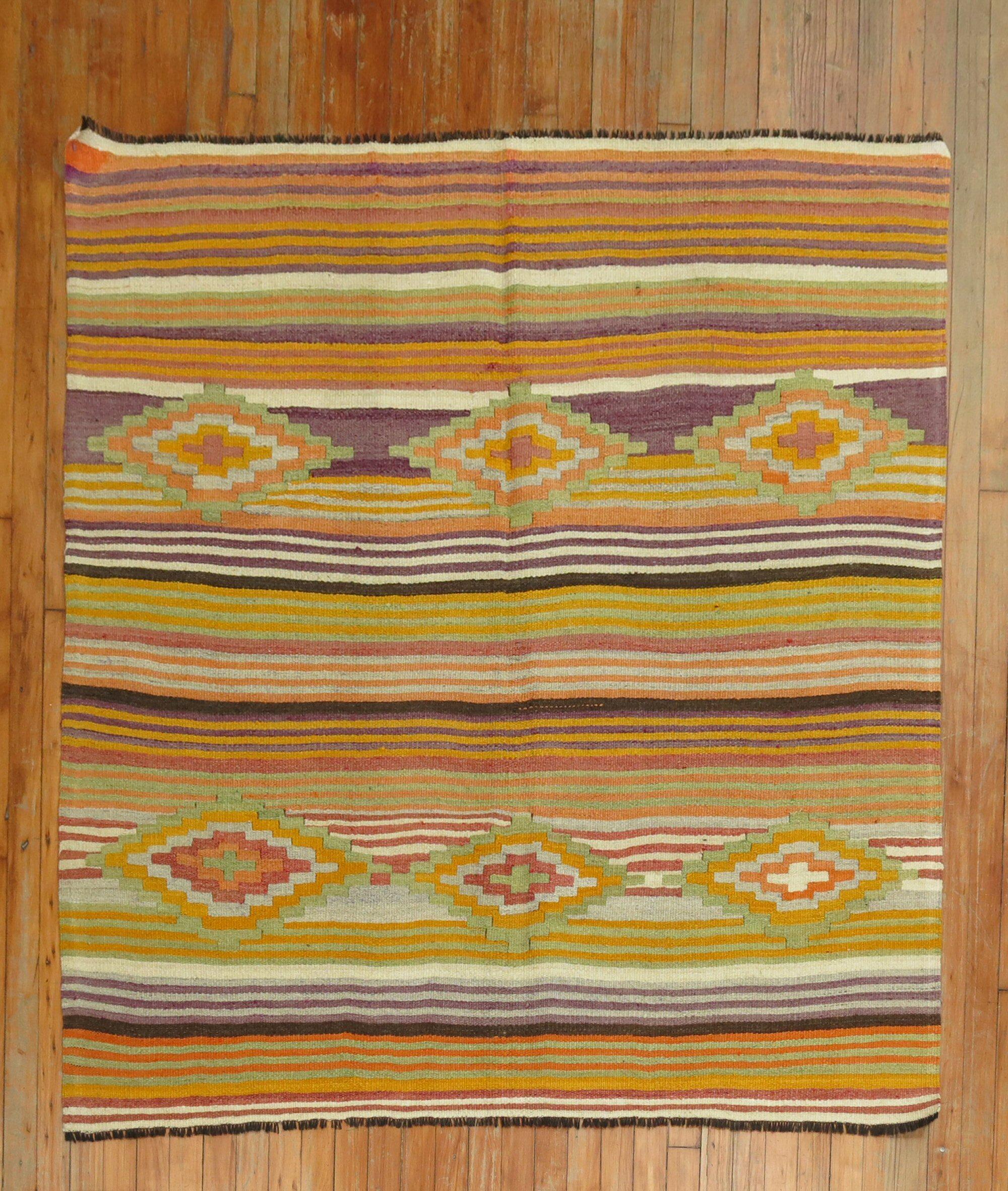 A square size vintage Turkish Kilim with a colorful striped design throughout.

5' x 5'3''