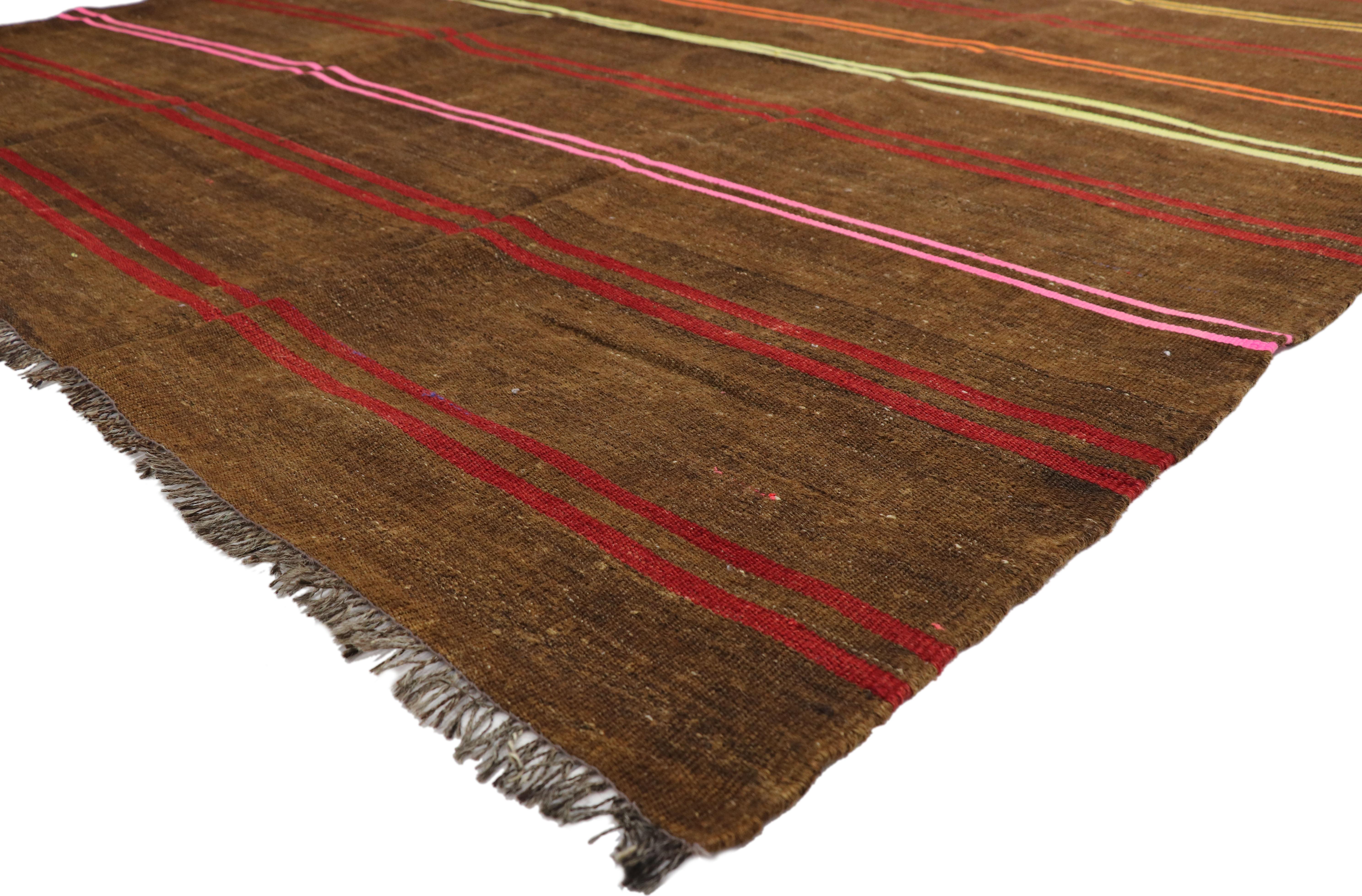 51334, vintage Turkish Striped Kilim Area rug with Bohemian Tribal style. This handwoven wool vintage Turkish Kilim rug features a series of thin bright double bands woven horizontally across a chocolate brown background. The poly-chromatic stripes