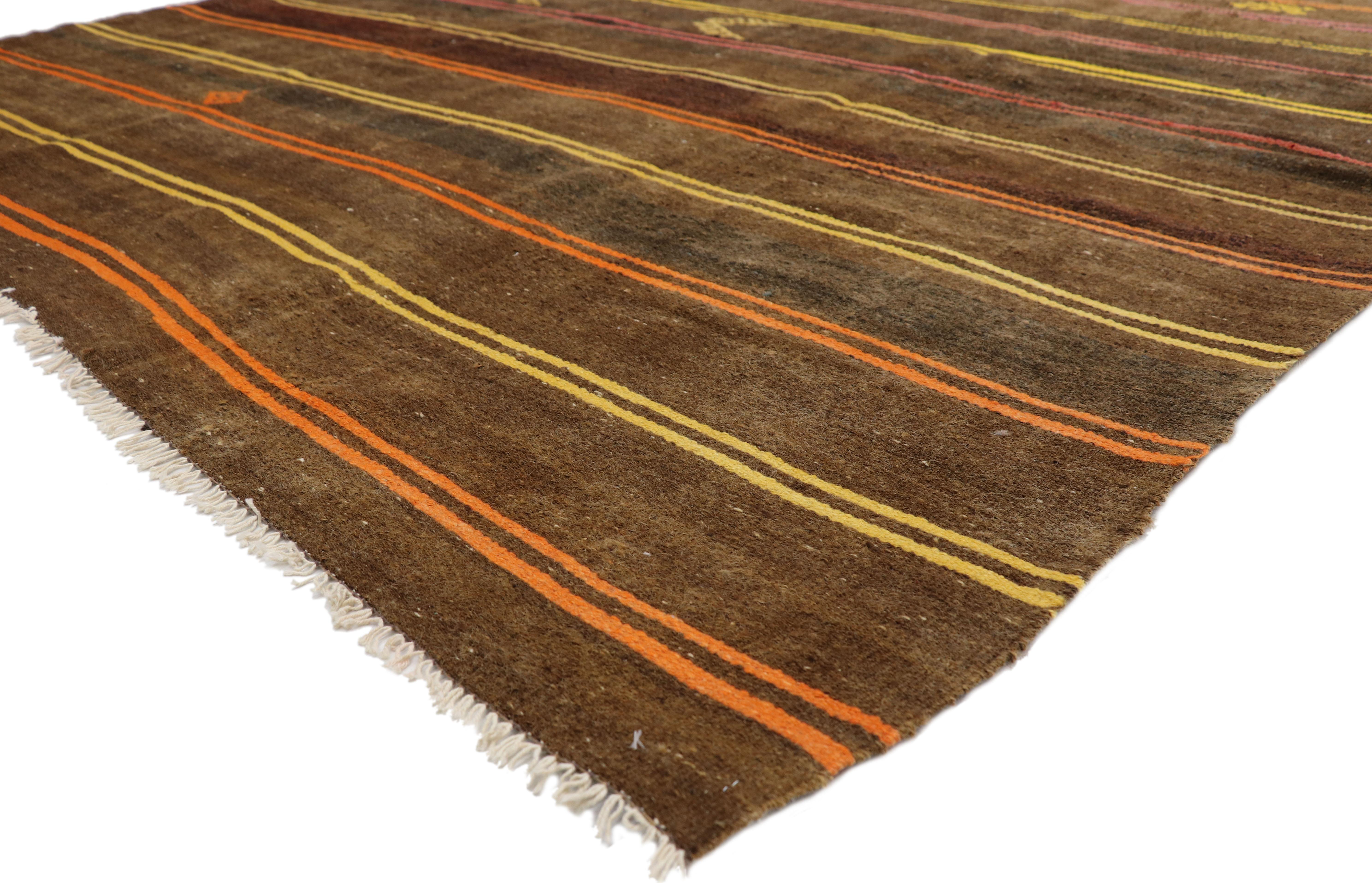 51321 vintage Turkish striped Kilim rug with Bohemian Tribal style, flat-weave rug. This hand woven wool vintage Turkish striped Kilim rug features double colored bands in alternating colors dotted with a few symbolic Turkish motifs on a warm brown