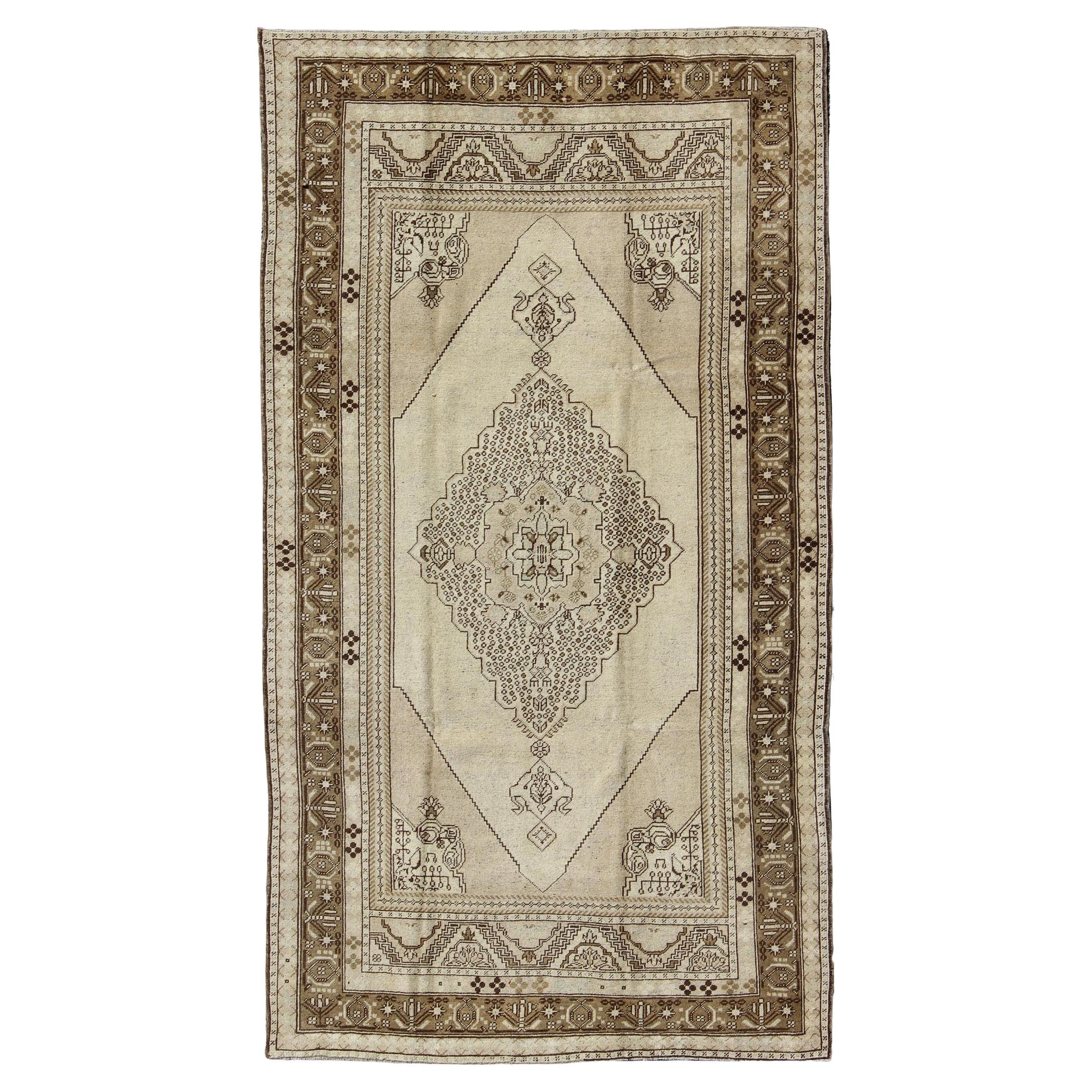 Vintage Turkish Stylized Medallion Oushak Rug in Sandy Neutrals and Earth Tones For Sale
